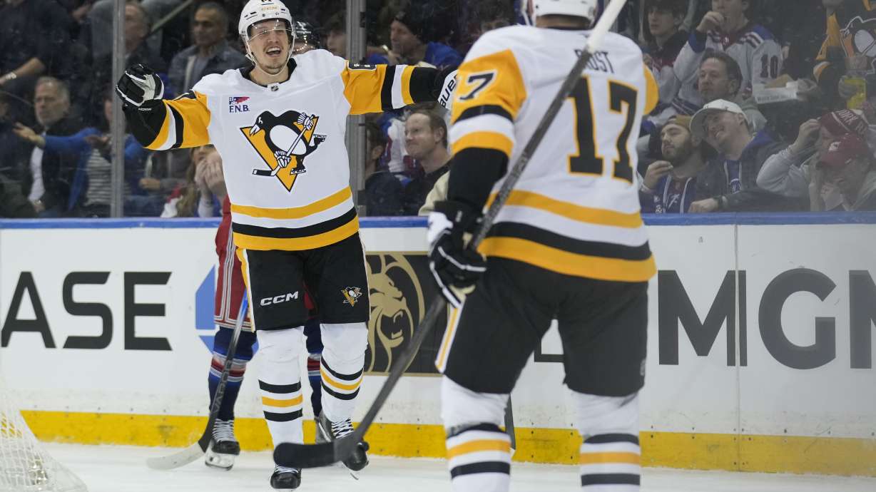 Pittsburgh Penguins' Rickard Rakell, left, celebrates his goal during the second period of an NHL hockey game against the New York Rangers Friday, Feb. 7, 2025, in New York.