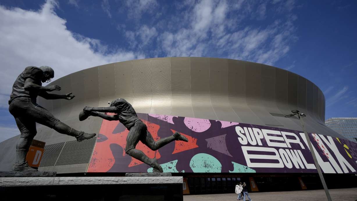 People walk outside the Caesars Superdome, Friday, Jan. 31, 2025, in New Orleans prior to the NFL Super Bowl 59 football game between the Philadelphia Eagles and the Kansas City Chiefs.