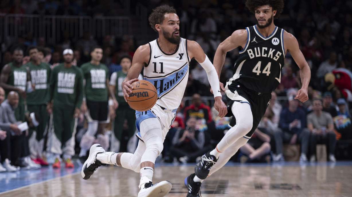 Atlanta Hawks guard Trae Young (11) dribbles the ball past Milwaukee Bucks guard Andre Jackson Jr. (44) during the first half of an NBA basketball game, Friday, Feb. 7, 2025, in Atlanta.