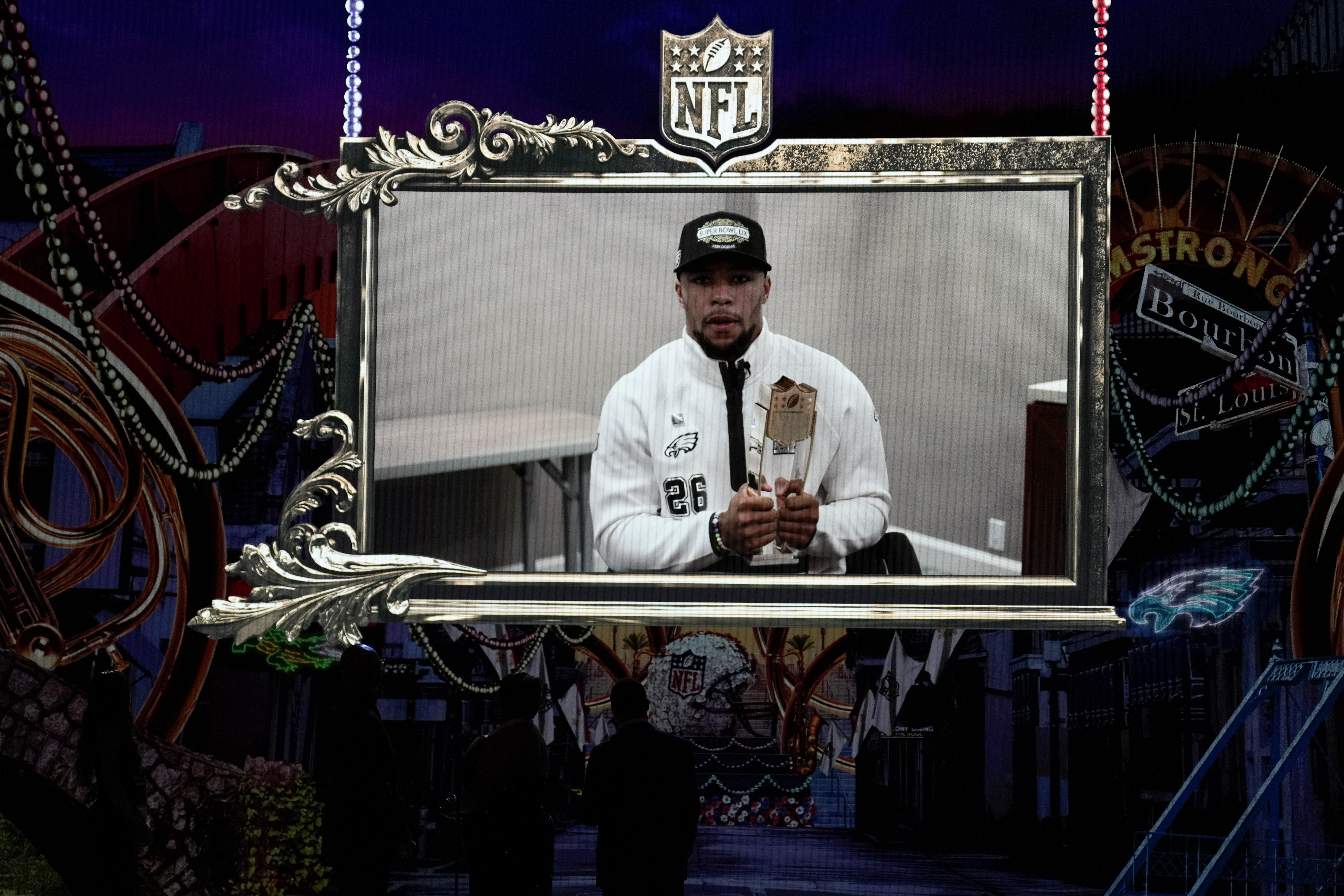 Philadelphia Eagles' Saquon Barkley, accepts the AP Offensive player of the year award on a screen during the NFL Honors award show ahead of the Super Bowl 59 football game, Thursday, Feb. 6, 2025, in New Orleans.