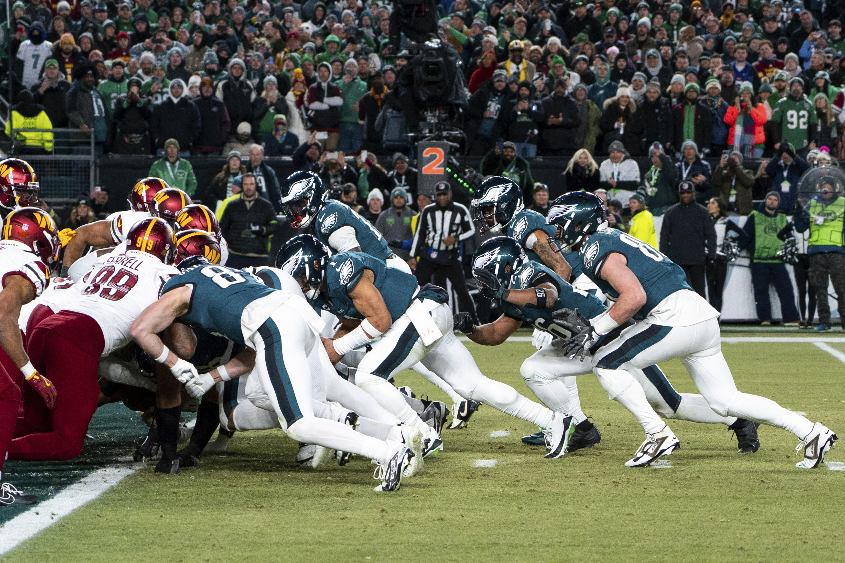 FILE - Philadelphia Eagles quarterback Jalen Hurts, center, and teammates run the tush push play during the NFL championship playoff football game against the Washington Commanders, Sunday, Jan. 26, 2025, in Philadelphia.