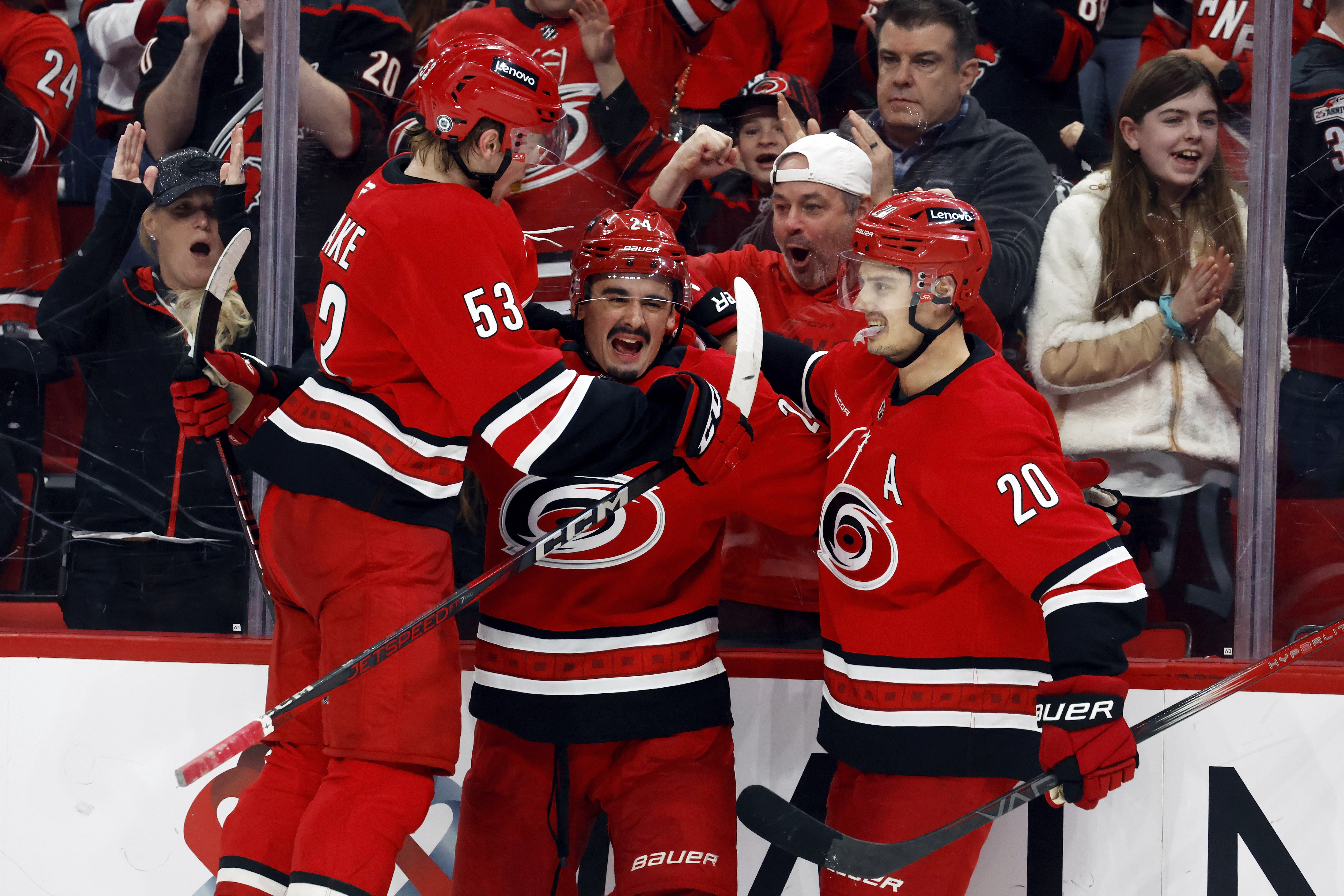 Carolina Hurricanes' Seth Jarvis, center, celebrates his goal with teammates Jackson Blake (53) and Sebastian Aho (20) during the second period of an NHL hockey game against the Utah Hockey Club in Raleigh, N.C., Saturday, Feb. 8, 2025.