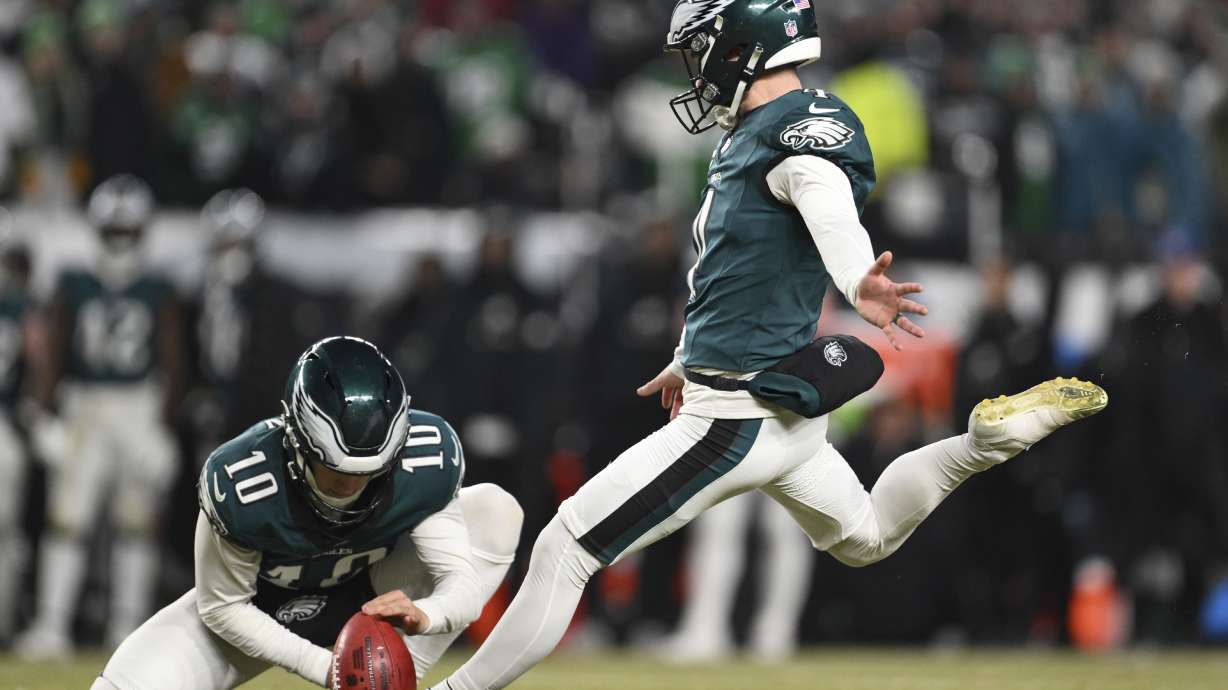 FILE - Philadelphia Eagles place kicker Jake Elliott kicks a field goal as punter Braden Mann (10) holds during the second half of an NFL wild card playoff football game against the Green Bay Packers, Sunday, Jan. 12, 2025, in Philadelphia.