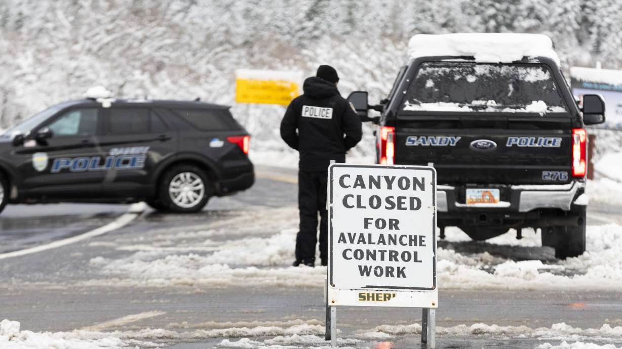 Police block the entrance to Little Cottonwood Canyon while the canyon is closed for avalanche prevention work on Saturday.