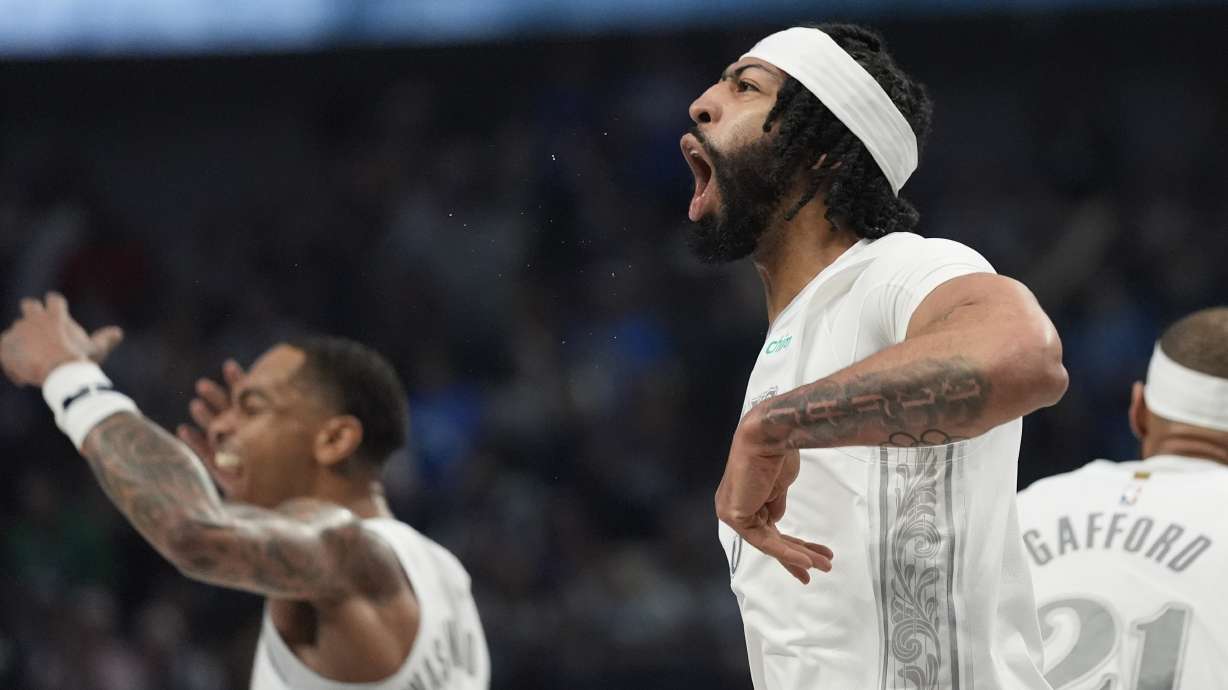 Dallas Mavericks forward Anthony Davis (3) yells to the fans with teammate P.J. Washington during the first half of an NBA basketball game against the Houston Rockets Saturday, Feb. 8, 2025, in Dallas.