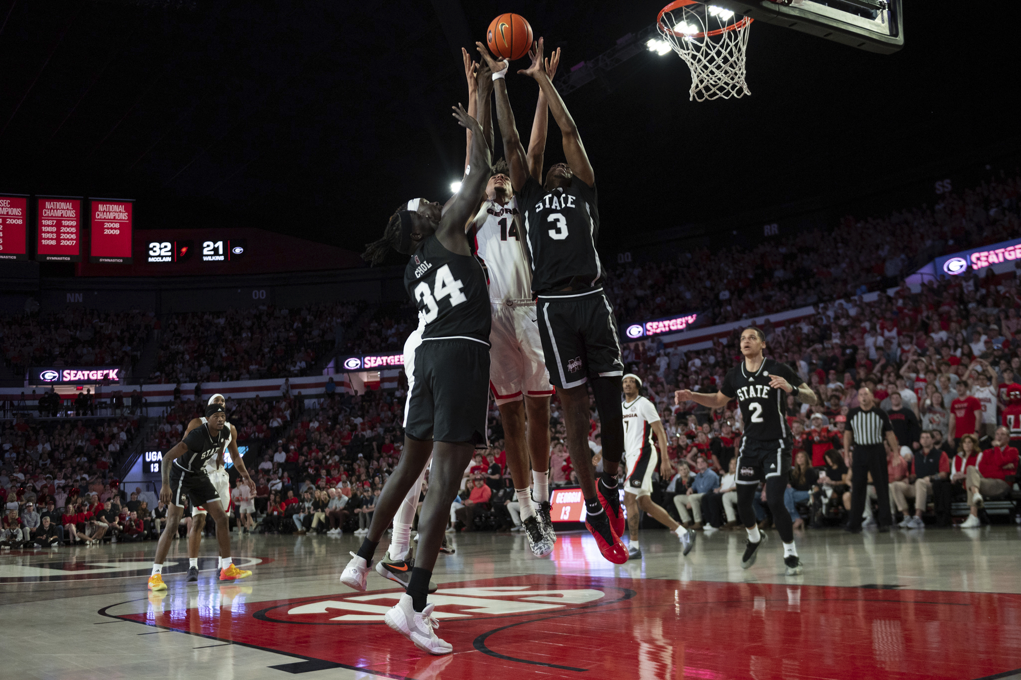 Georgia forward Asa Newell (14), Mississippi State forward KeShawn Murphy (3), Mississippi State center Gai Chol (34) and Georgia center Somto Cyril (6) reach to rebound the ball during the first half of an NCAA college basketball game, Saturday, Feb. 8, 2025, in Athens, Ga.