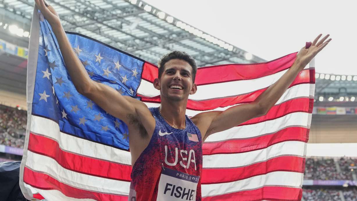 FILE - Grant Fisher, of the United States, celebrates after winning the bronze medal in the men's 5000 meters final at the 2024 Summer Olympics, Aug. 10, 2024, in Saint-Denis, France.