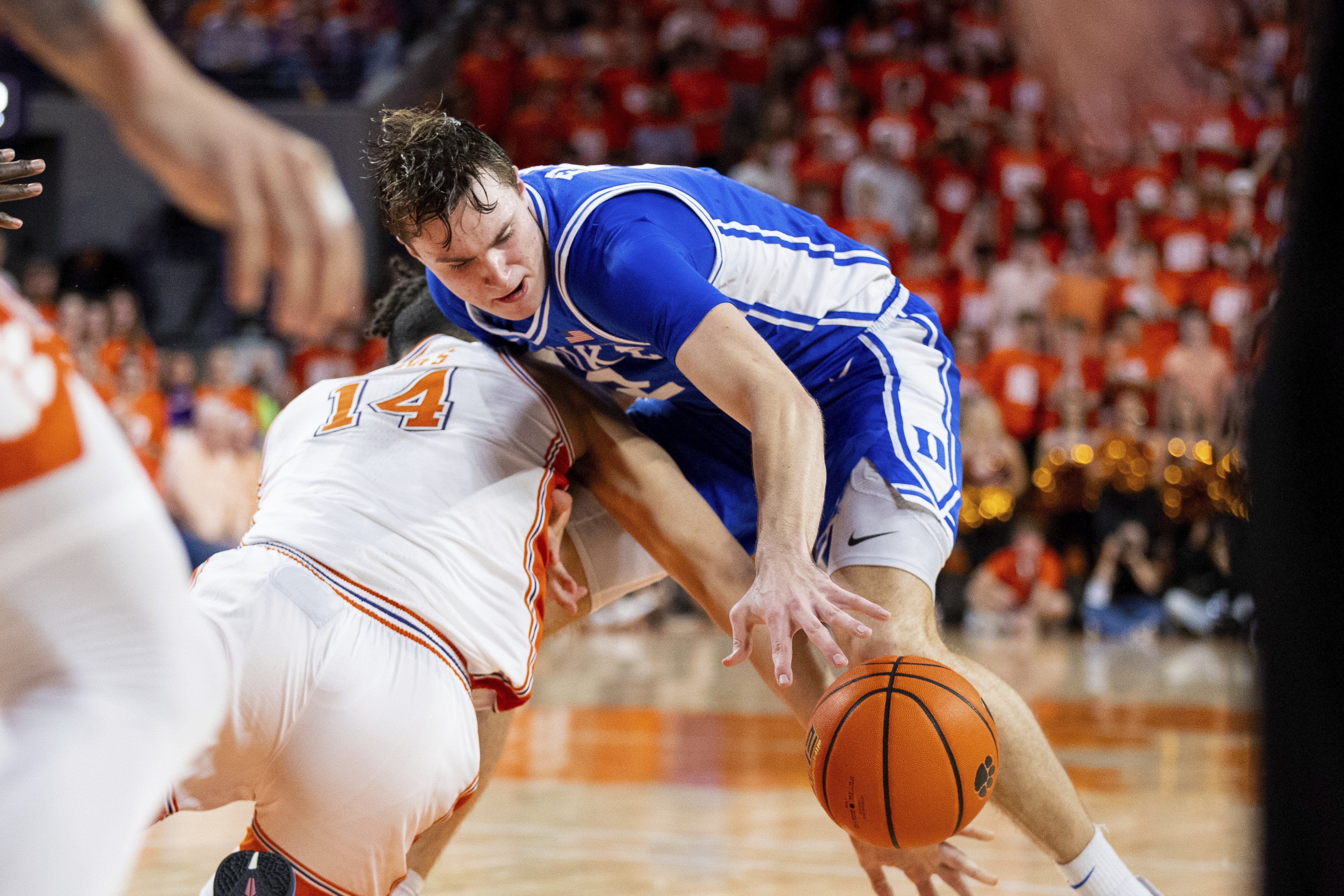 Clemson center Christian Reeves (14) knocks the ball away from Duke guard Cooper Flagg during the second half of an NCAA college basketball game on Saturday, Feb. 8, 2025, in Clemson, S.C.