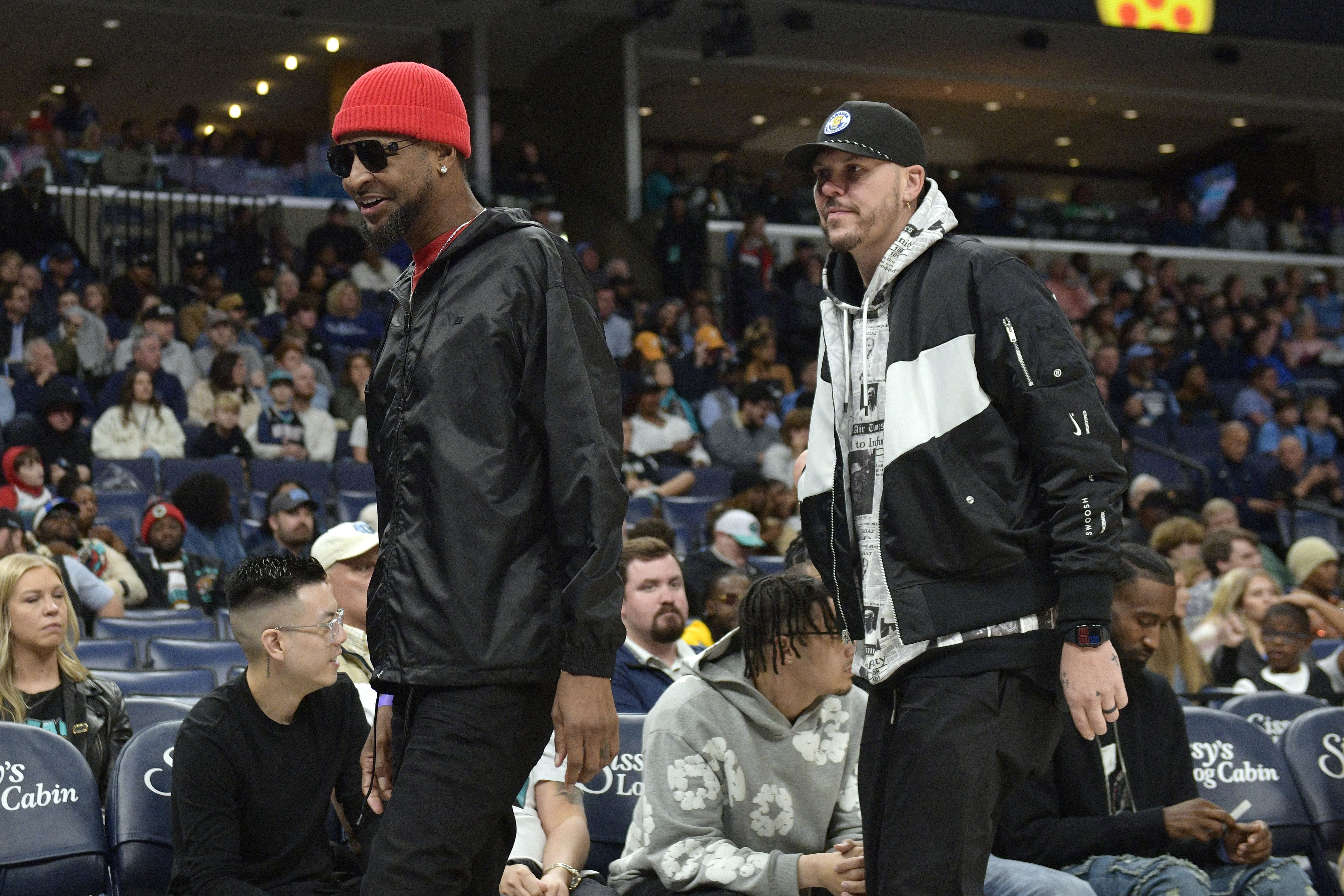 FILE - Tee Morant, left, father of NBA player Ja Morant, and Mike Miller, right, walk along the sideline in the first half of an NBA basketball game between the Indiana Pacers and the Memphis Grizzlies, Dec. 1, 2024, in Memphis, Tenn.