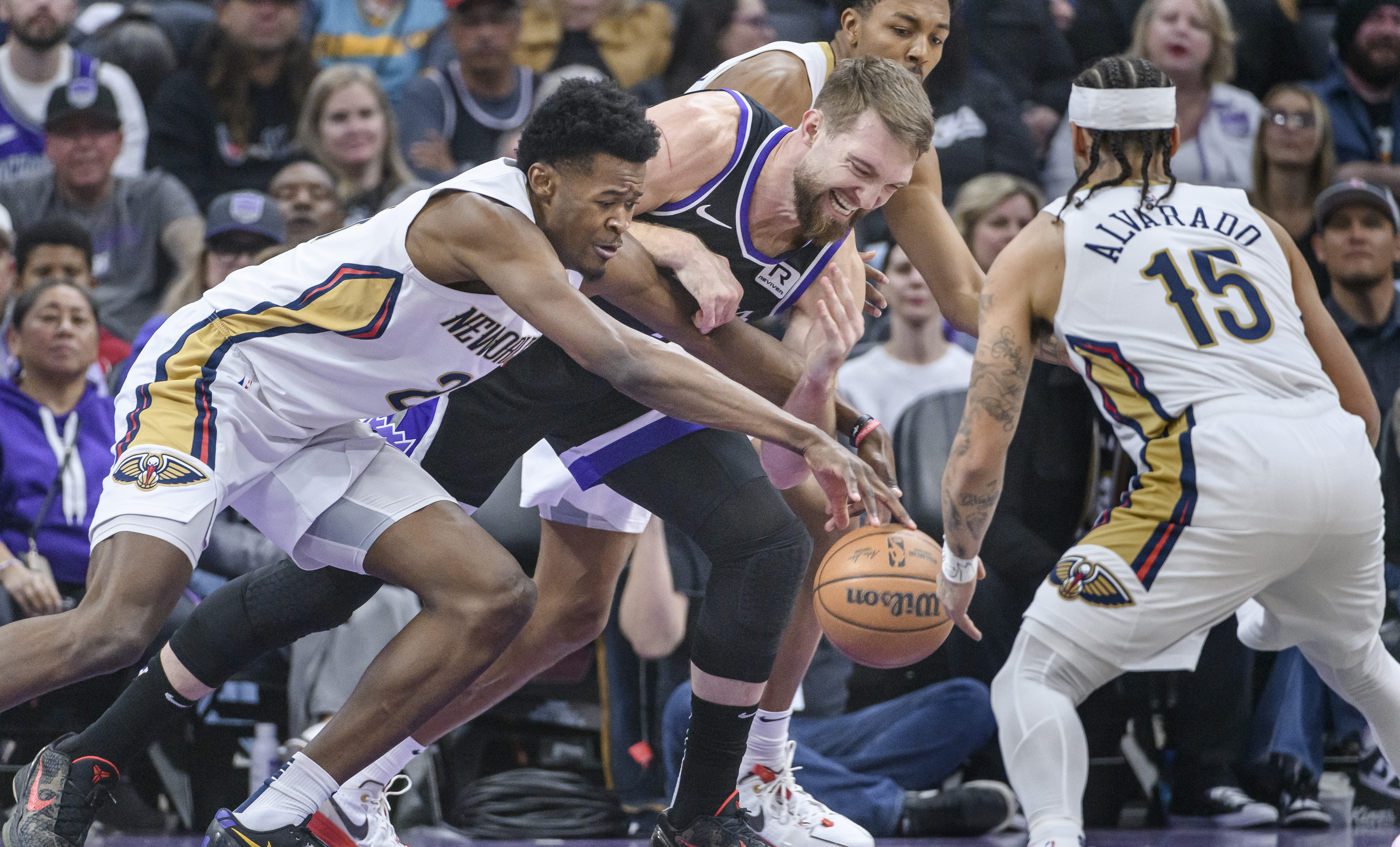 New Orleans Pelicans center Yves Missi, left, and Sacramento Kings forward Domantas Sabonis battle for the ball during the first half of an NBA basketball game in Sacramento, Calif., Saturday, Feb. 8, 2025.