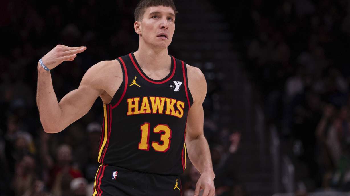 Atlanta Hawks guard Bogdan Bogdanovic (13) celebrates his three-point shot during the second half of an NBA basketball game, Thursday, Jan. 23, 2025, in Atlanta.