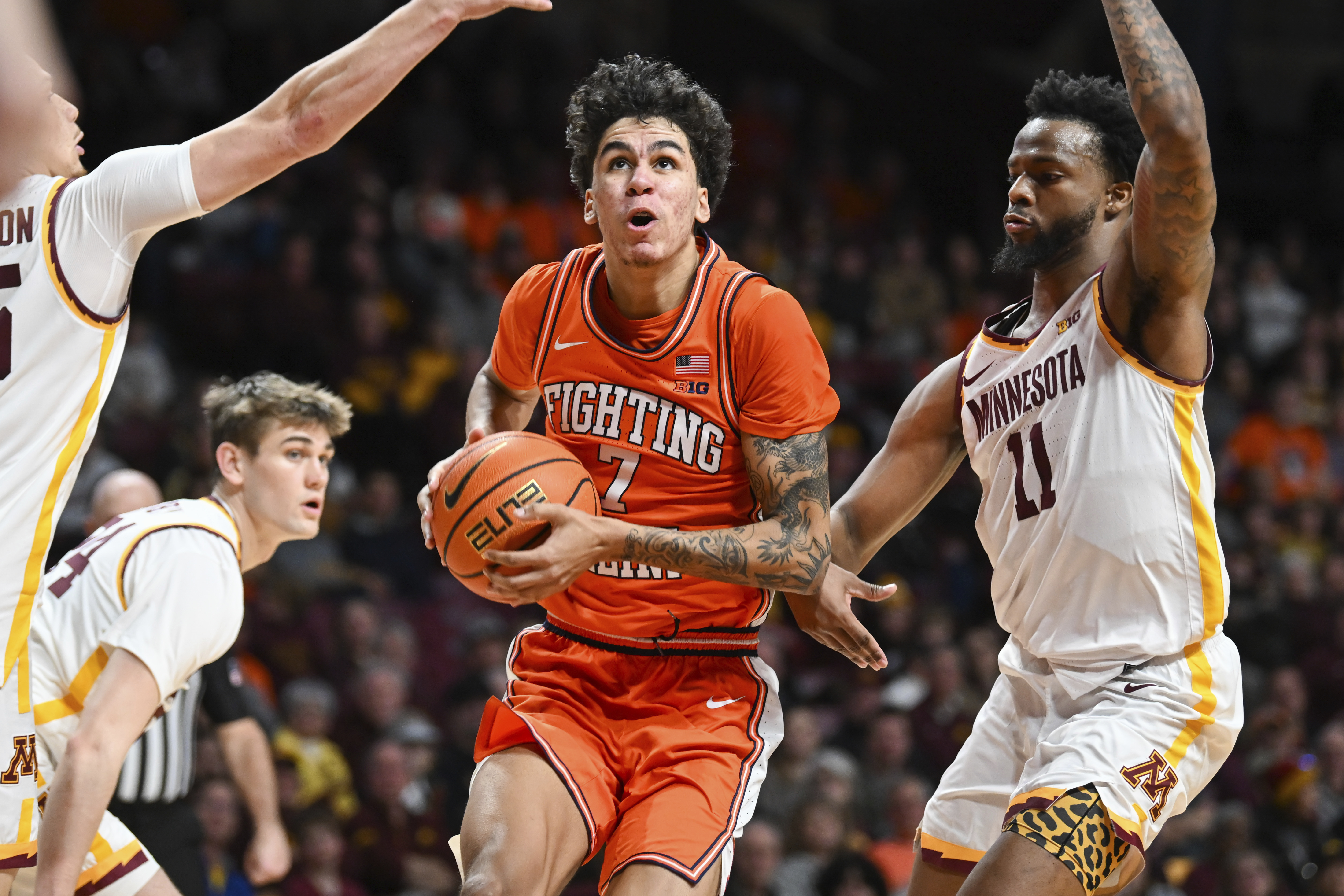 Illinois forward Will Riley drives past Minnesota guard Femi Odukale during the second half of an NCAA college basketball game on Saturday, Feb. 8, 2025, in Minneapolis.