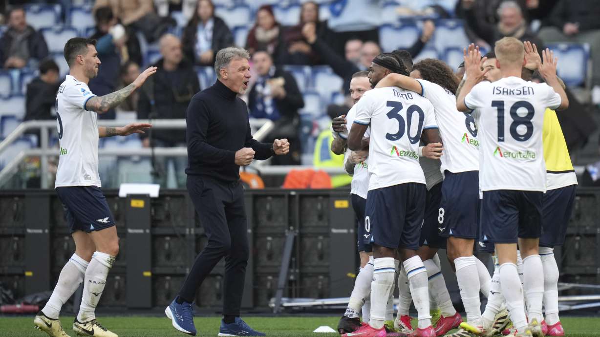 Lazio players and Lazio's head coach Marco Baroni, centre, celebrate after Lazio's Pedro scored his side's second goal during a Serie A soccer match between Lazio and Monza, at Rome's Olympic Stadium, Sunday, Feb. 9, 2025.