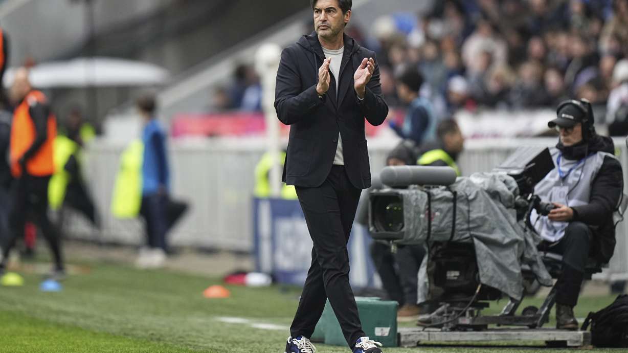 Lyon's head coach Paulo Fonseca walks along the sideline during the French League One soccer match between Lyon and Reims at the Groupama stadium in Decines, outside Lyon, central France, Sunday, Feb. 9, 2025.