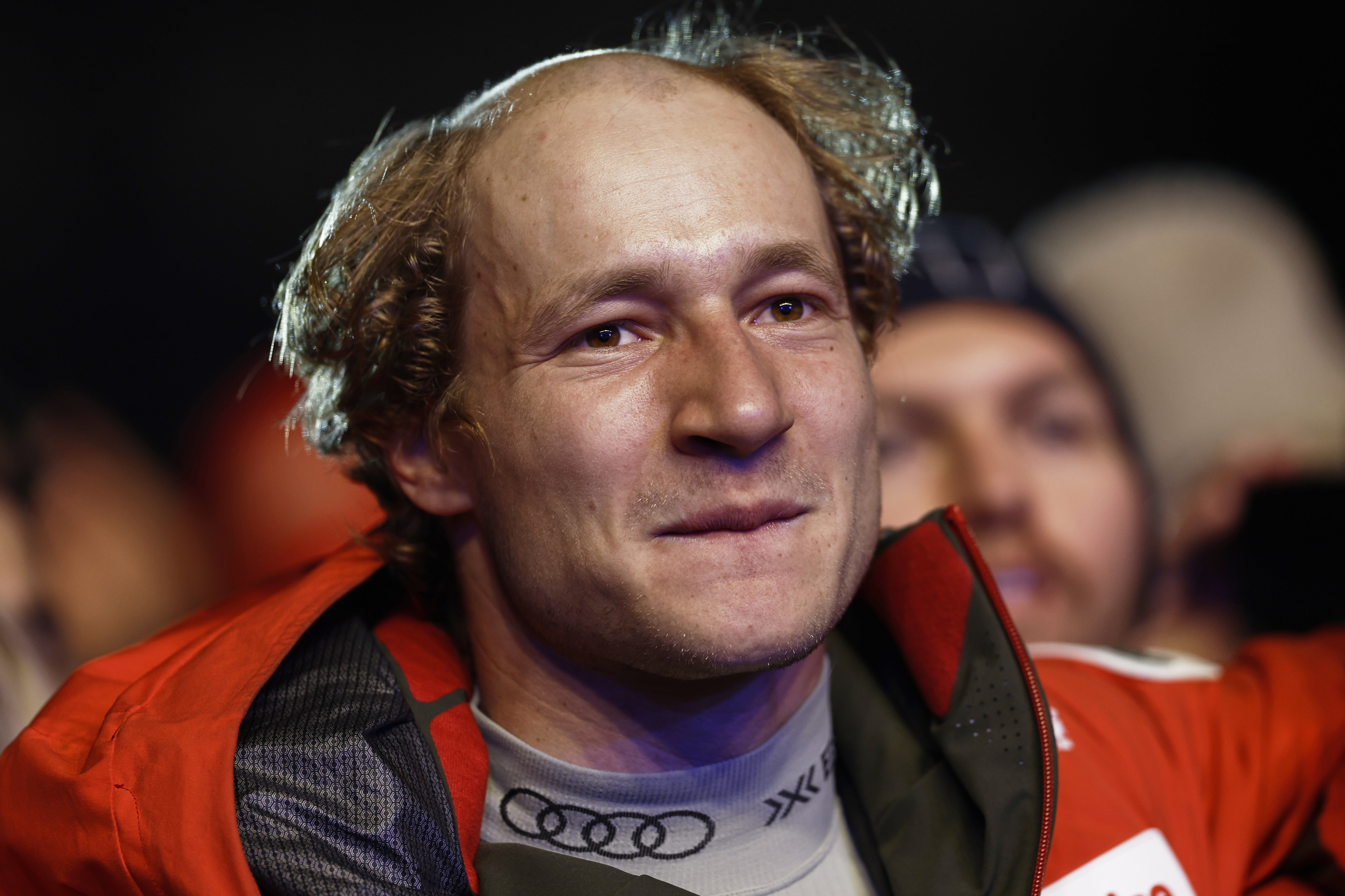 Switzerland's Marco Odermatt, with his hair partially shaved off, arrives at the medal ceremony for a men's downhill race, at the Alpine Ski World Championships, in Saalbach-Hinterglemm, Austria, Sunday, Feb. 9, 2025.