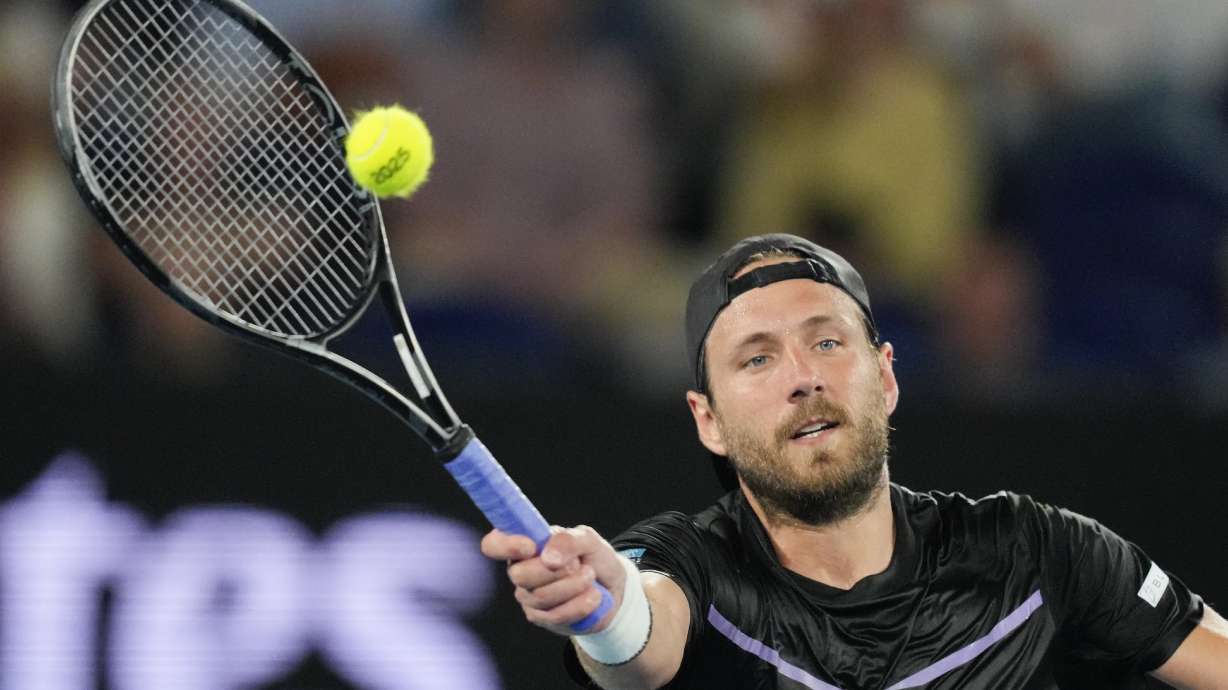 FILE - Lucas Pouille of France plays a forehand return during a first round match at the Australian Open tennis championship in Melbourne, Australia, Jan. 12, 2025.