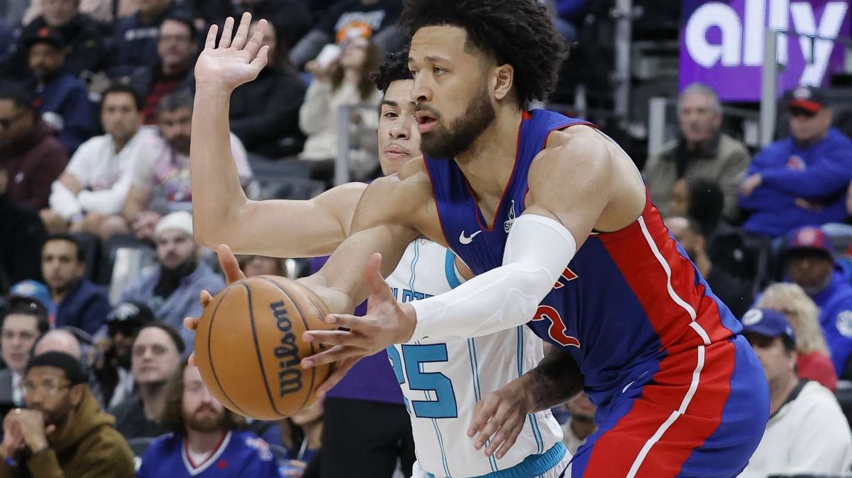 Detroit Pistons guard Cade Cunningham, right, grabs the ball against Charlotte Hornets guard KJ Simpson, left, during the first half of an NBA basketball game Sunday, Feb. 9, 2025, in Detroit.