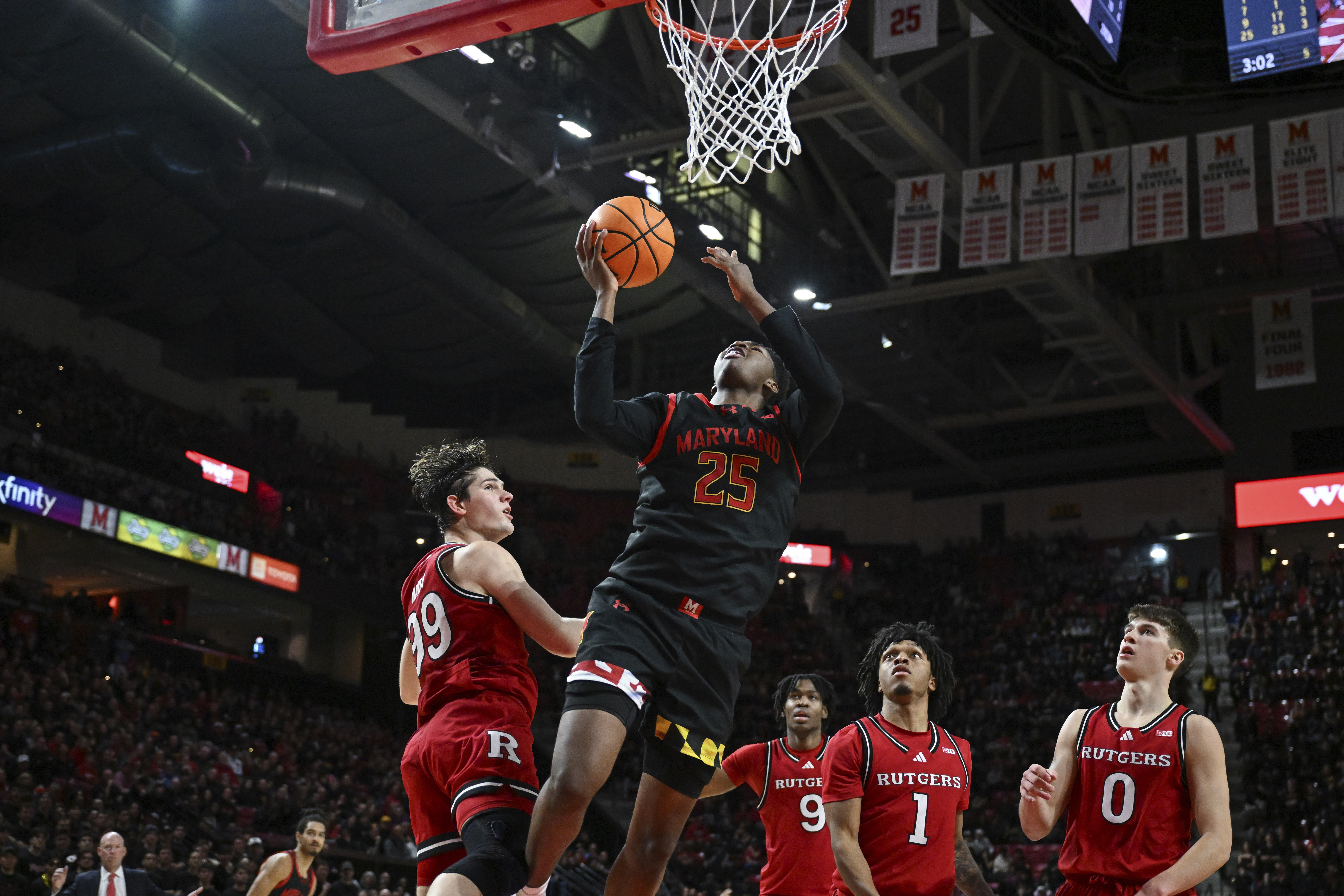 Maryland center Derik Queen (25) goes to the basket for a layup against several Rutgers defenders during the second half of an NCAA college basketball game, Sunday, Feb. 9, 2025, in College Park, Md.