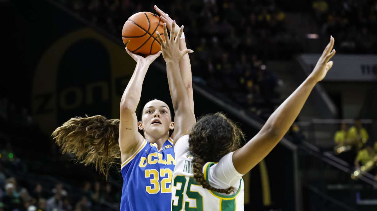 UCLA forward Angela Dugalic (32) shoots against Oregon forward Ehis Etute (35) in the second half of an NCAA college basketball game in Eugene, Ore., Sunday, Feb. 9, 2025. UCLA beat Oregon 62-52.
