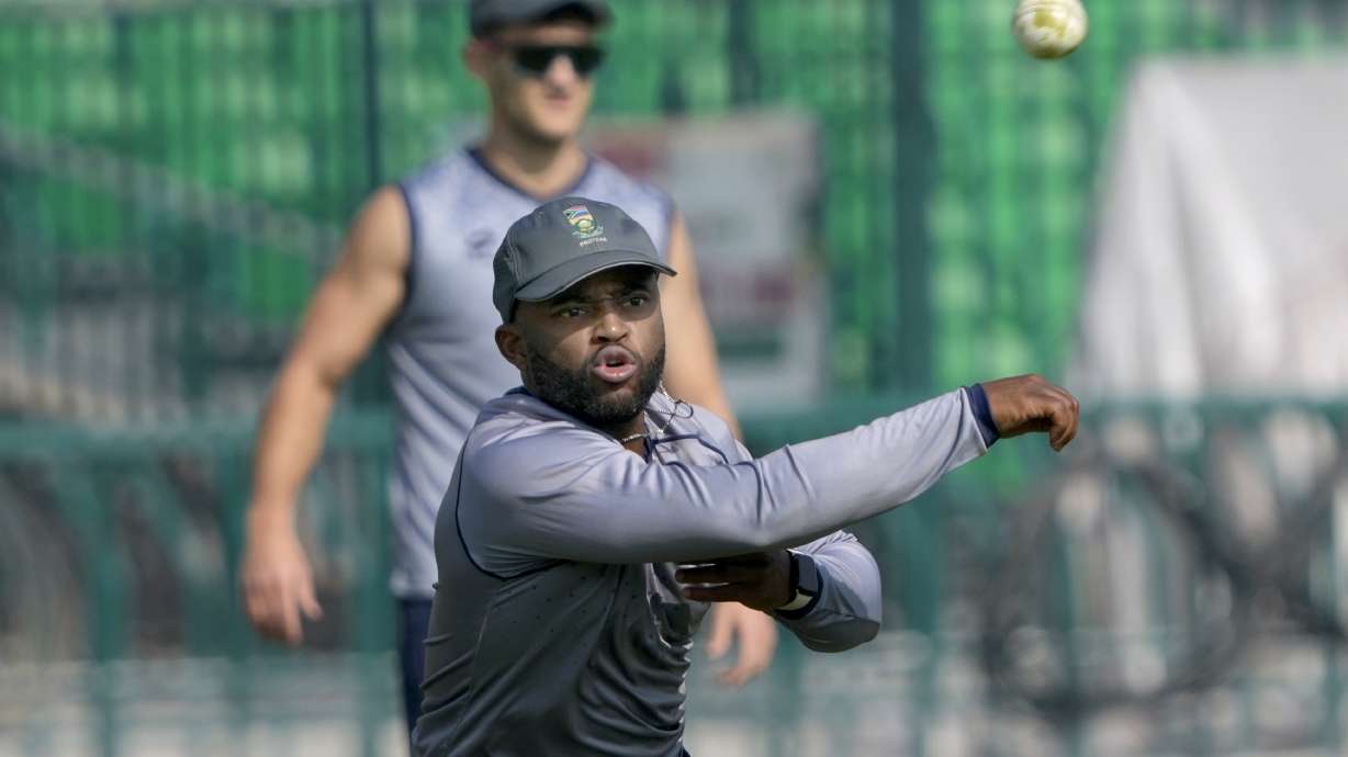South Africa's skipper Temba Bavuma, front, throws the ball during a training session, in Lahore, Pakistan, Sunday, Feb. 9, 2025.