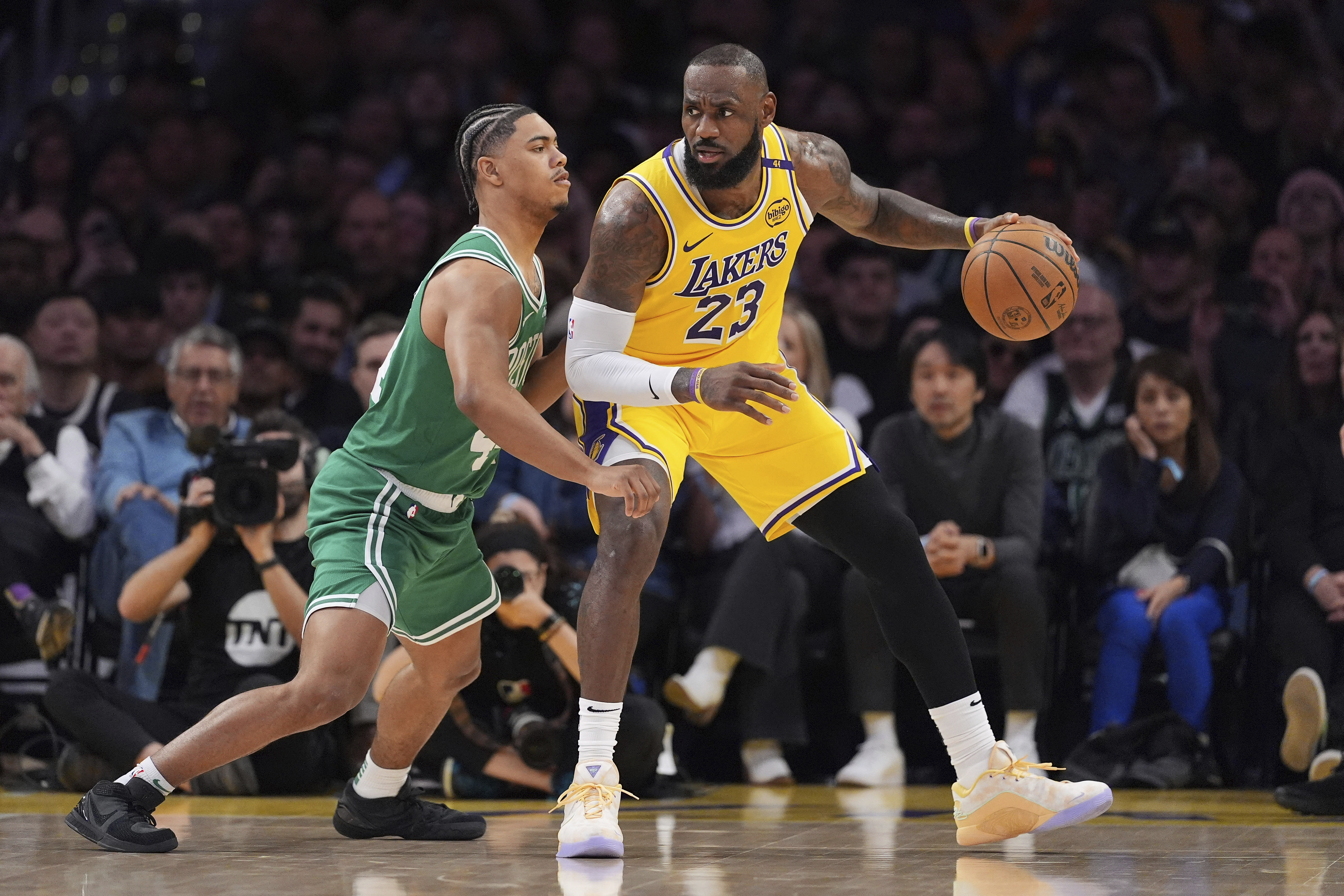 Los Angeles Lakers forward LeBron James, right, tries to back down Boston Celtics guard Jaden Springer during the second half of an NBA basketball game, Thursday, Jan. 23, 2025, in Los Angeles.