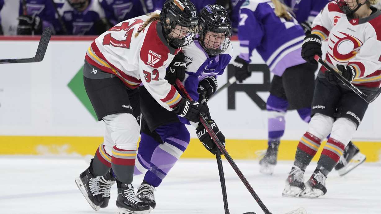 Ottawa Charge forward Rebecca Leslie and Minnesota Frost forward Claire Butorac battle for the puck during the second period of a PWHL hockey game, Tuesday, Jan. 21, 2025, in St. Paul, Minn.