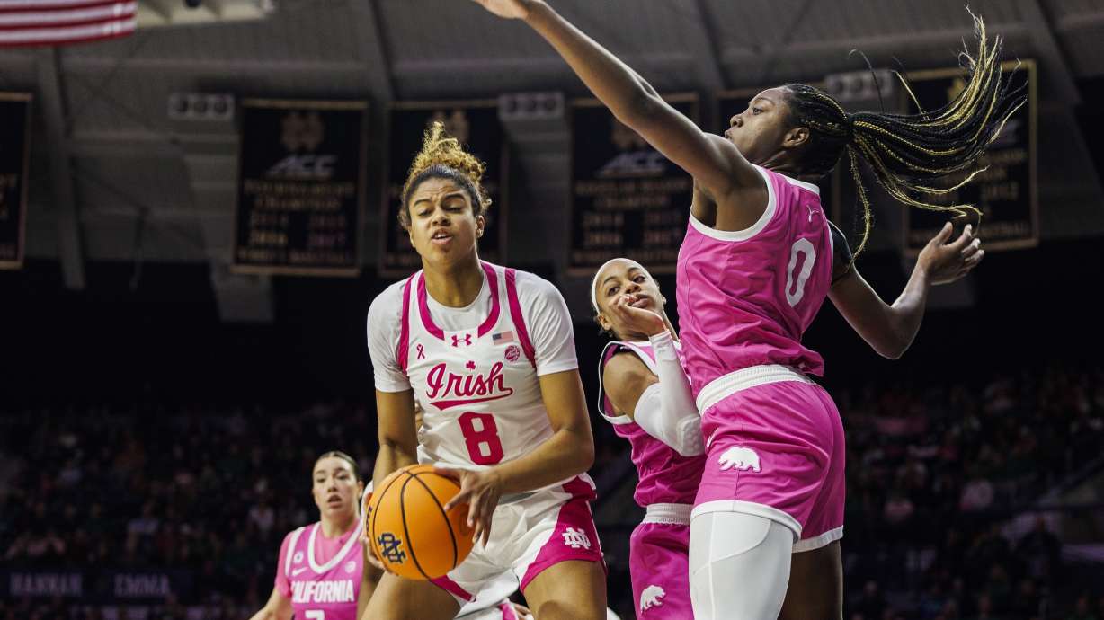 Notre Dame guard Cassandre Prosper (8) rebounds around California center Ugonne (Michelle) Onyiah (0) during the second half of an NCAA college basketball game Sunday, Feb. 9, 2025, in South Bend, Ind.