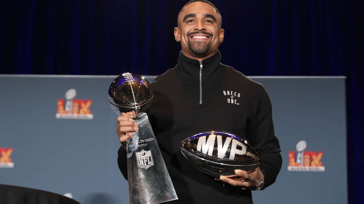 Philadelphia Eagles quarterback Jalen Hurts poses with the Vince Lombardi Super Bowl trophy and the Pete Rozelle MVP trophy during a news conference the morning after the NFL Super Bowl 59 football game between the Eagles and the Kansas City Chiefs, Monday, Feb. 10, 2025, in New Orleans.