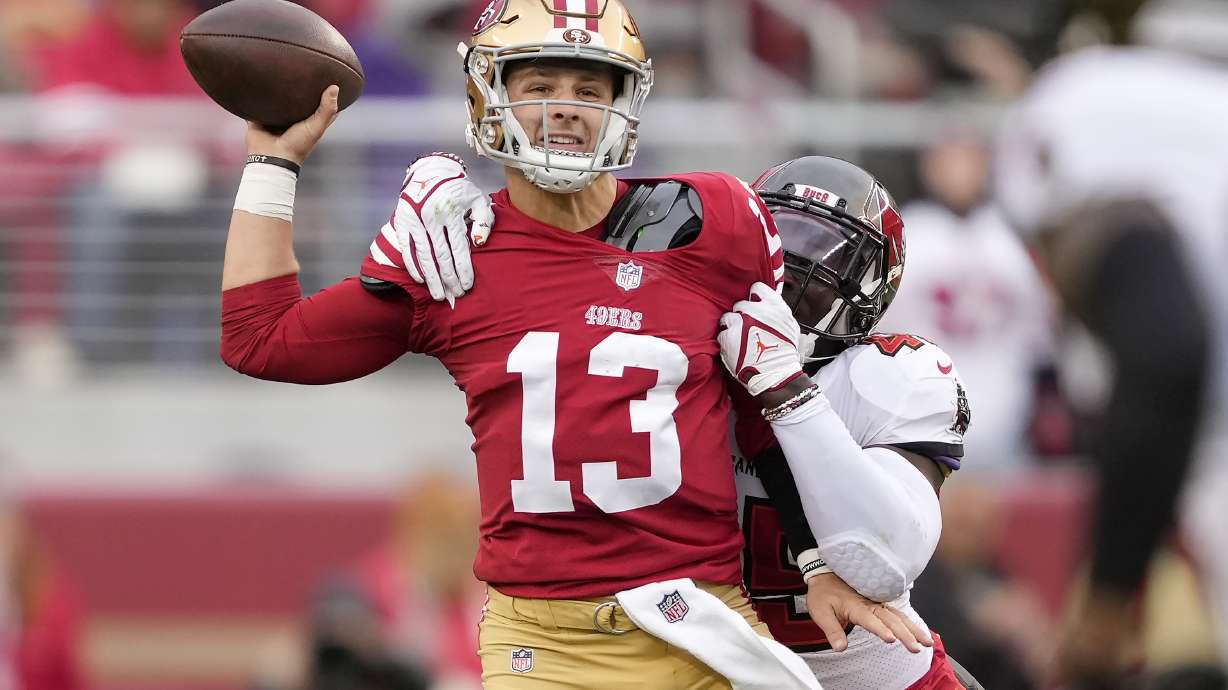 FILE - San Francisco 49ers quarterback Brock Purdy passes as Tampa Bay Buccaneers linebacker Devin White applies pressure during the first half of an NFL football game in Santa Clara, Calif., Dec. 11, 2022.