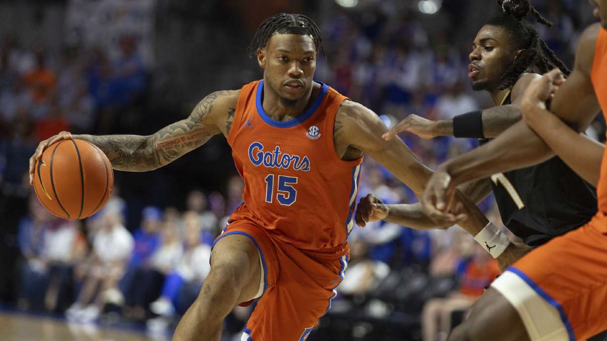 Florida guard Alijah Martin (15) drives against Vanderbilt guard Jason Edwards (1) during the second half of an NCAA college basketball game Tuesday, Feb. 4, 2025, in Gainesville, Fla.