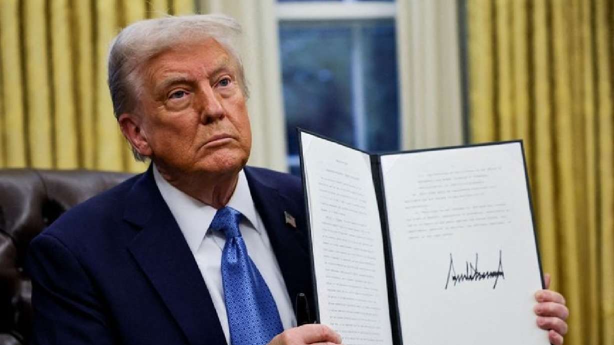 President Donald Trump holds a signed executive order in the Oval Office at the White House in Washington, Jan. 31. A judge kept his block on Trump's buyout plan for federal employees in place on Monday.