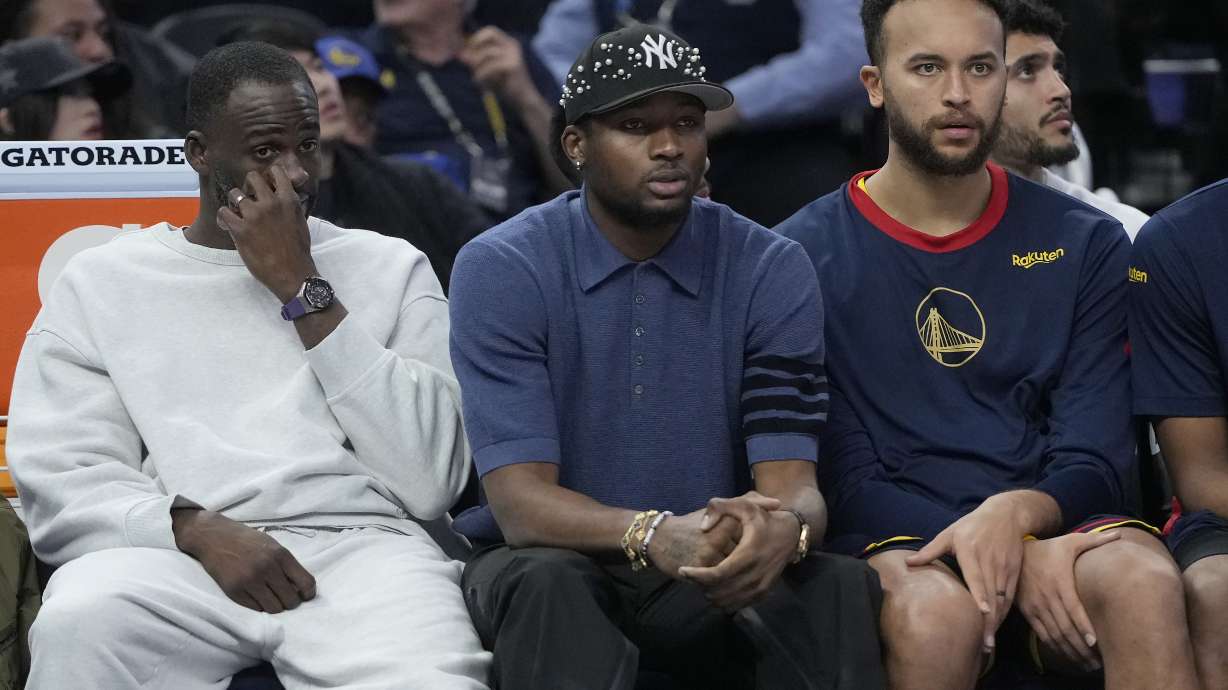 Golden State Warriors forward Draymond Green, from left, reacts on the bench with forward Jonathan Kuminga, and forward Kyle Anderson during the second half of an NBA basketball game against the Phoenix Suns in San Francisco, Friday, Jan. 31, 2025.