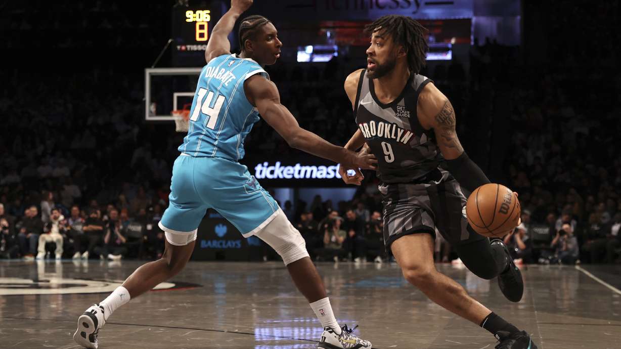 Brooklyn Nets' Trendon Watford, right, dribbles the ball against Charlotte Hornets' Moussa Diabate, left, during the first half of an NBA basketball game, Monday, Feb. 10, 2025, in New York.