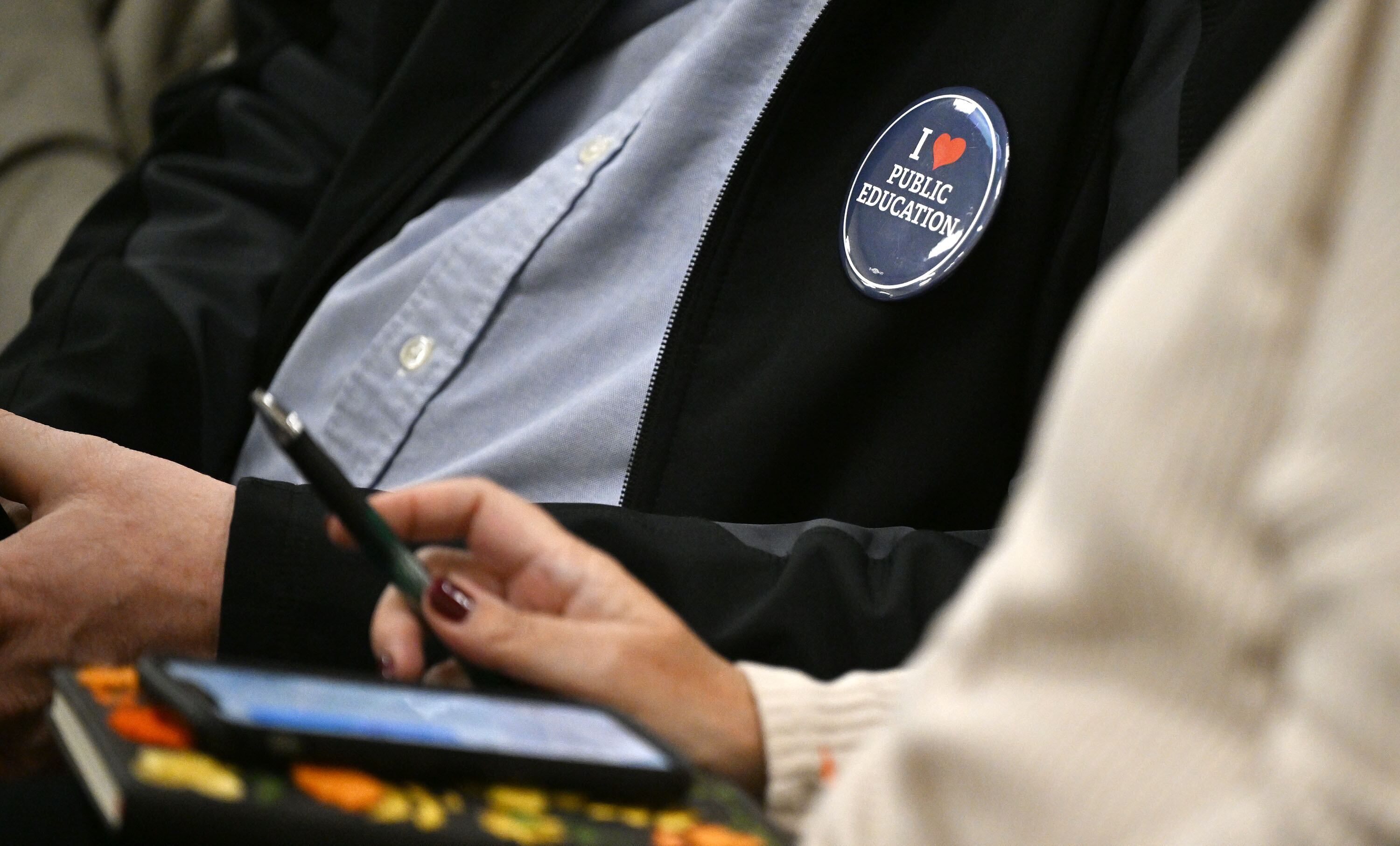 A member of the audience wears a pin in the House Education Committee as Utah House Speaker Mike Schultz, presents HB447, Statewide Catalyst Campus Model, at the Capitol in Salt Lake City on Monday.