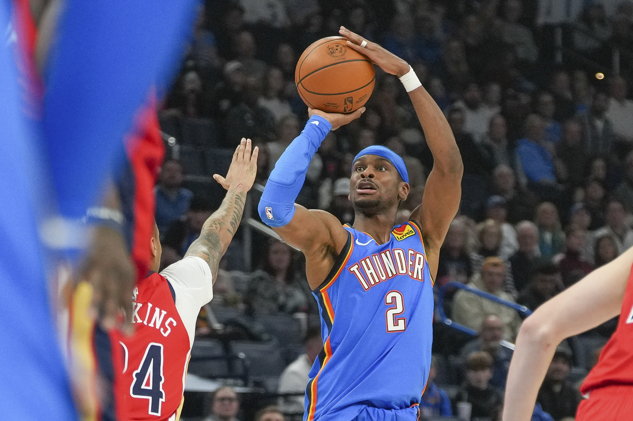 Oklahoma City Thunder guard Shai Gilgeous-Alexander (2) shoots over New Orleans Pelicans guard Jordan Hawkins, left, during the first half of an NBA basketball game, Monday, Feb. 10, 2025, in Oklahoma City.
