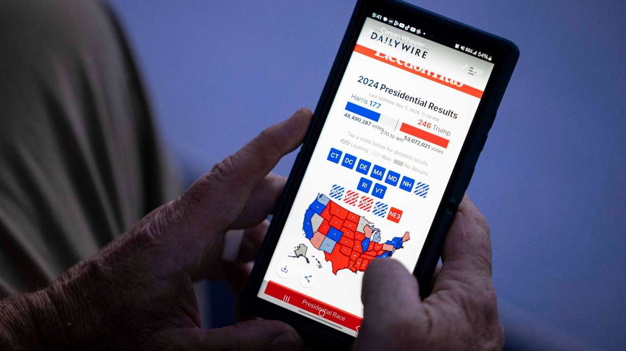 Ben Wheeler, of Orem, watches his phone as general election results come in on Nov. 5. The governor and Republican leaders in the House and Senate all agree the state needs to speed up election results.