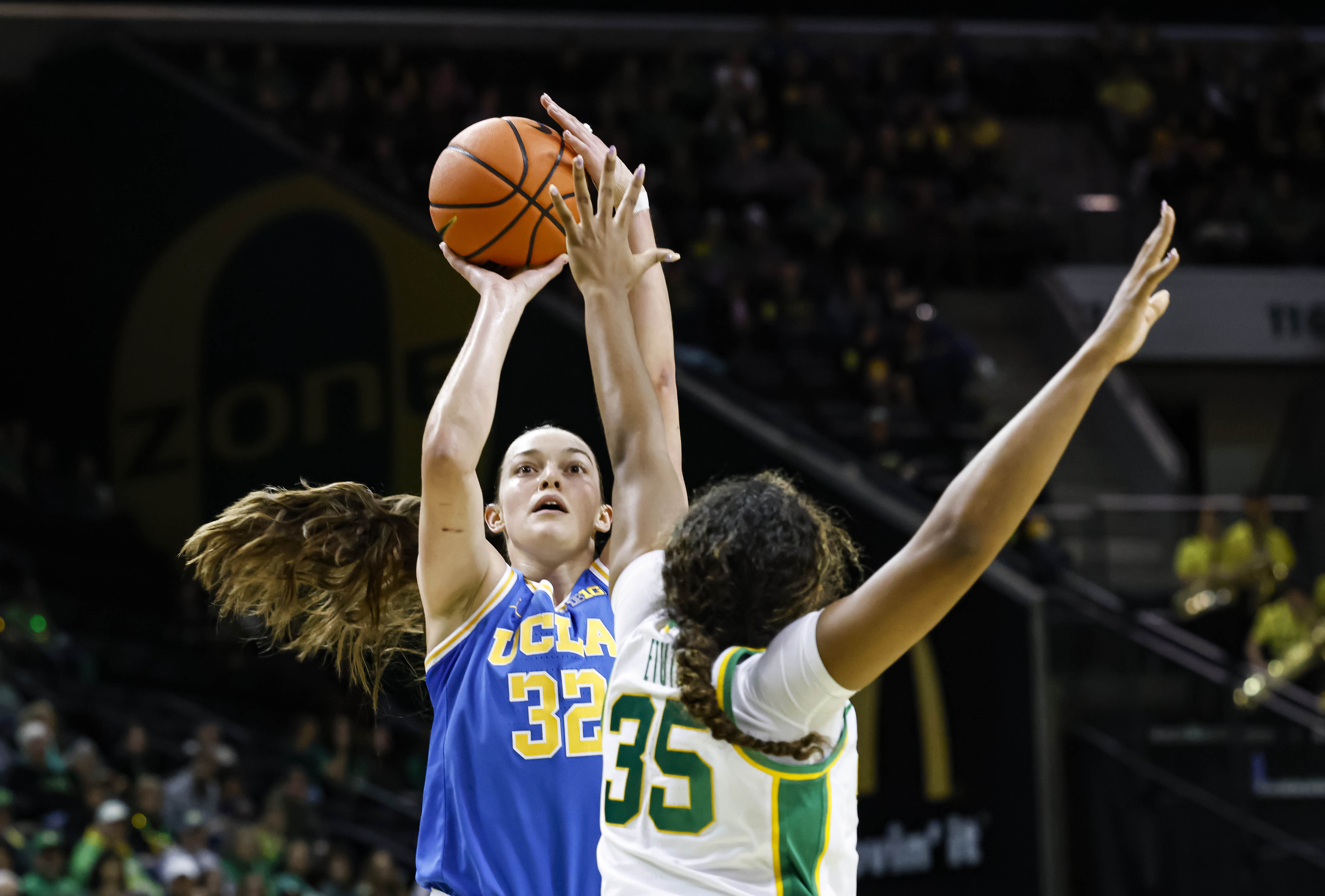 UCLA forward Angela Dugalic (32) shoots against Oregon forward Ehis Etute (35) in the second half of an NCAA college basketball game in Eugene, Ore., Sunday, Feb. 9, 2025. UCLA beat Oregon 62-52.