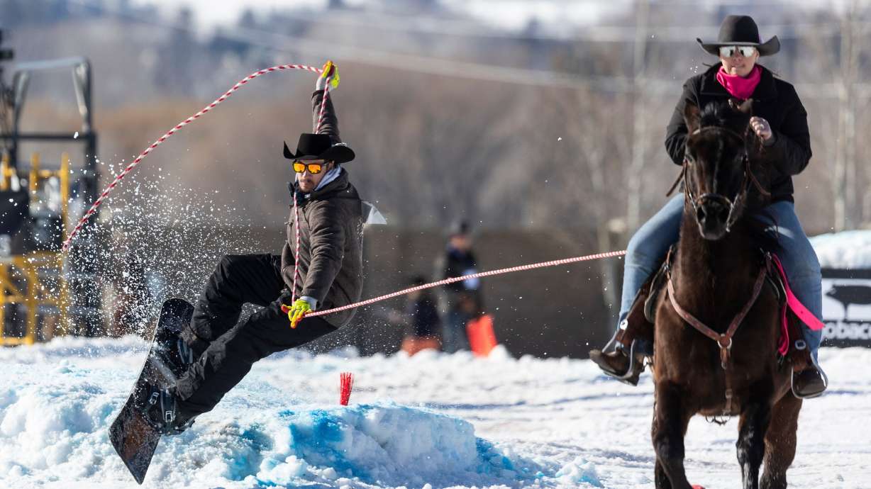 A snowboarder is pulled by a rider during the 2024 Utah Skijoring competition at the Wasatch County Event Complex in Heber City, Feb. 17, 2024. The event is back this weekend.