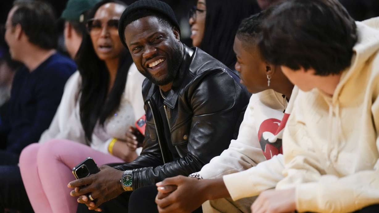 FILE - Comedian Kevin Hart sits in the front row during the first half of an NBA basketball game between the Memphis Grizzlies and the Los Angeles Lakers in Los Angeles, Jan. 20, 2023.