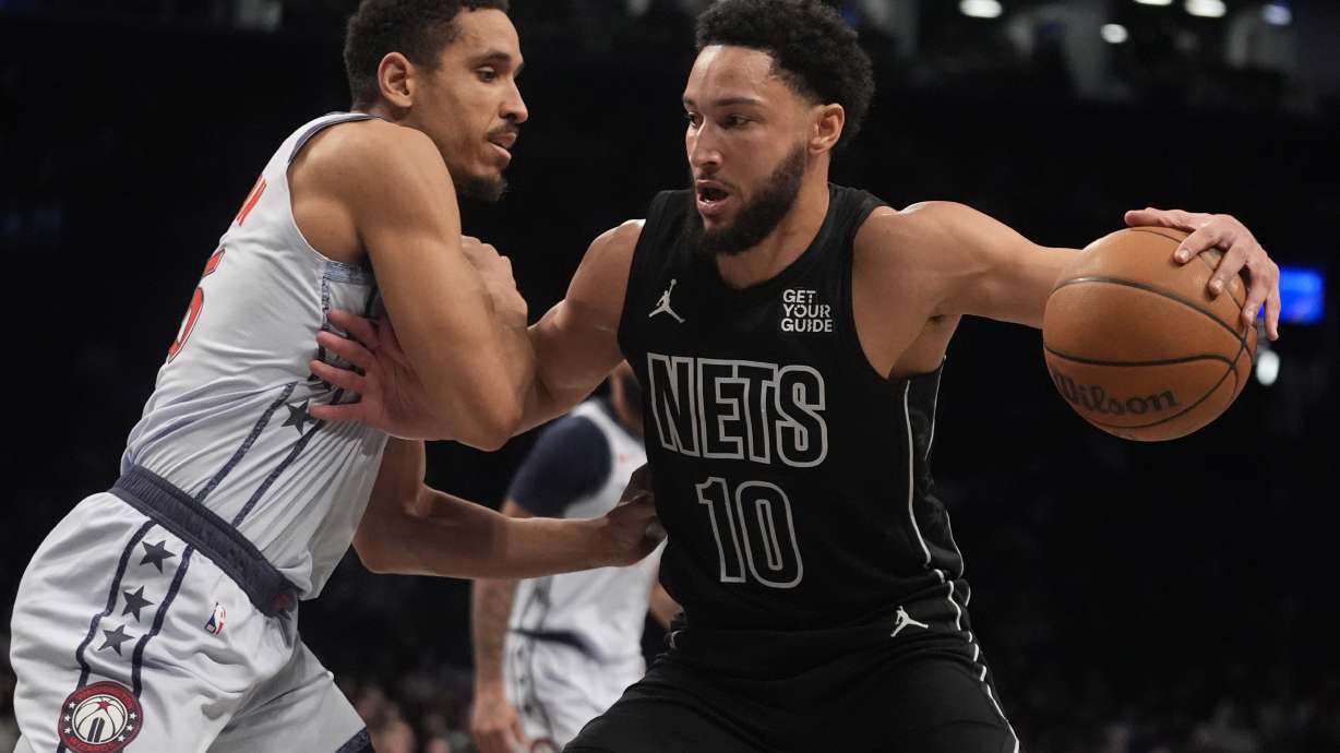 Washington Wizards' Malcolm Brogdon, left, defends Brooklyn Nets' Ben Simmons during the first half of an NBA basketball game Wednesday, Feb. 5, 2025, in New York.