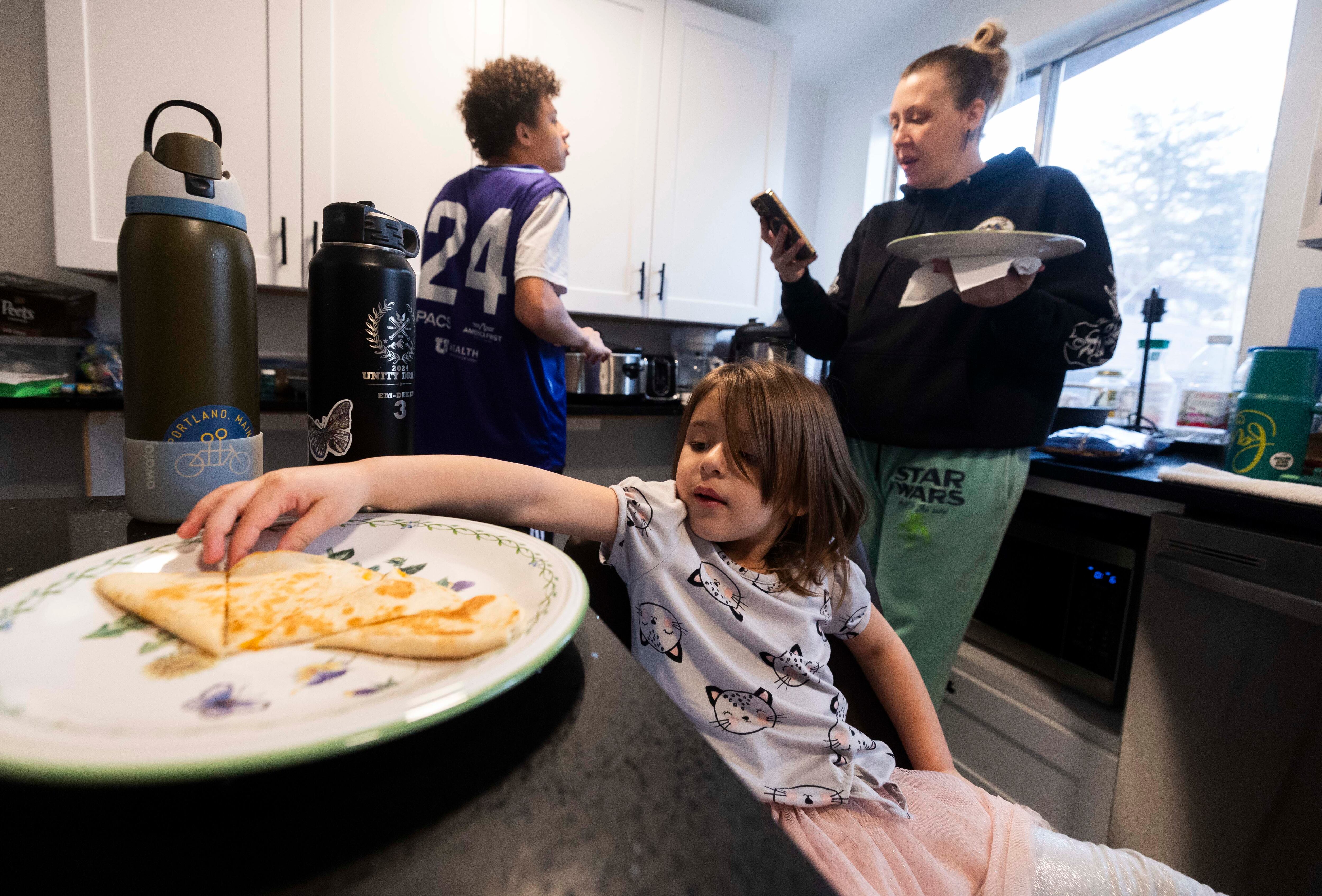 Amelia Diaz, 4, reaches for a slice of a quesadilla, at the Diaz home in Midvale on Tuesday. Over the last few years, the Diaz family has experienced an increase in income which has highlighted the difficulties of transitioning away from welfare benefits without losing all of the benefits at once.