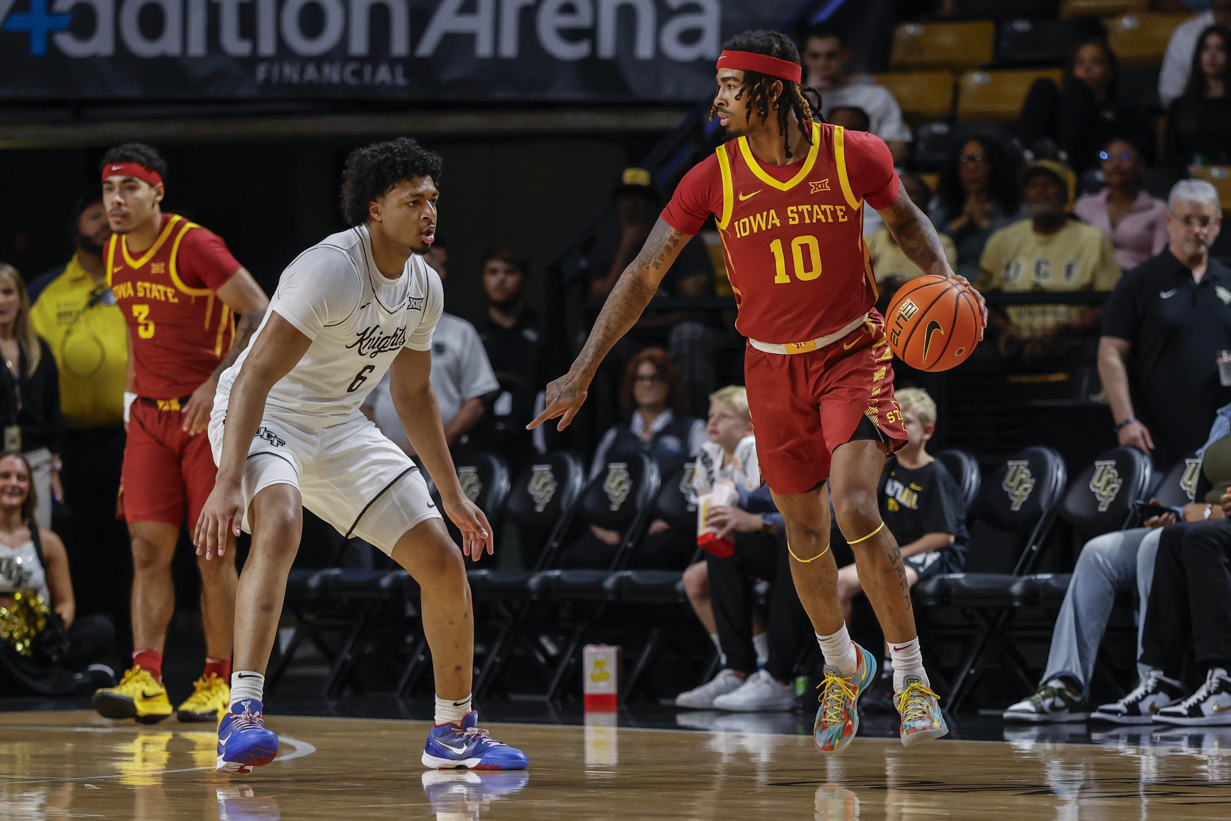 Iowa State guard Keshon Gilbert (10) starts offense as he is defended by Central Florida guard Dallan Coleman (6) during the first half of an NCAA college basketball game, Tuesday Feb. 11, 2025 in Orlando, Fla.