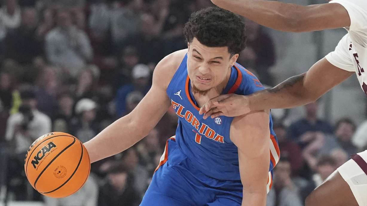 Florida guard Walter Clayton Jr. (1) runs into the hands of a Mississippi State defender during the first half of an NCAA college basketball game, Wednesday, Feb. 11, 2025, in Starkville, Miss.