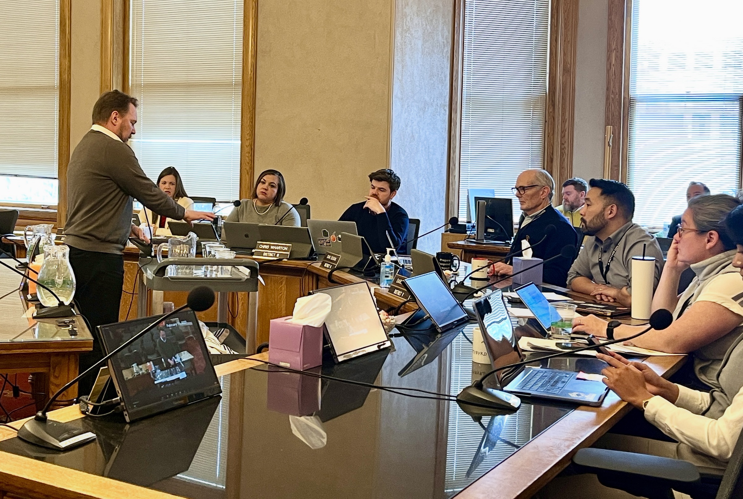Andrew Johnston, director of homeless policy and outreach for Salt Lake City, uses water cups to explain homelessness and crime issues in Salt Lake City to members of the Salt Lake City Council on Tuesday.