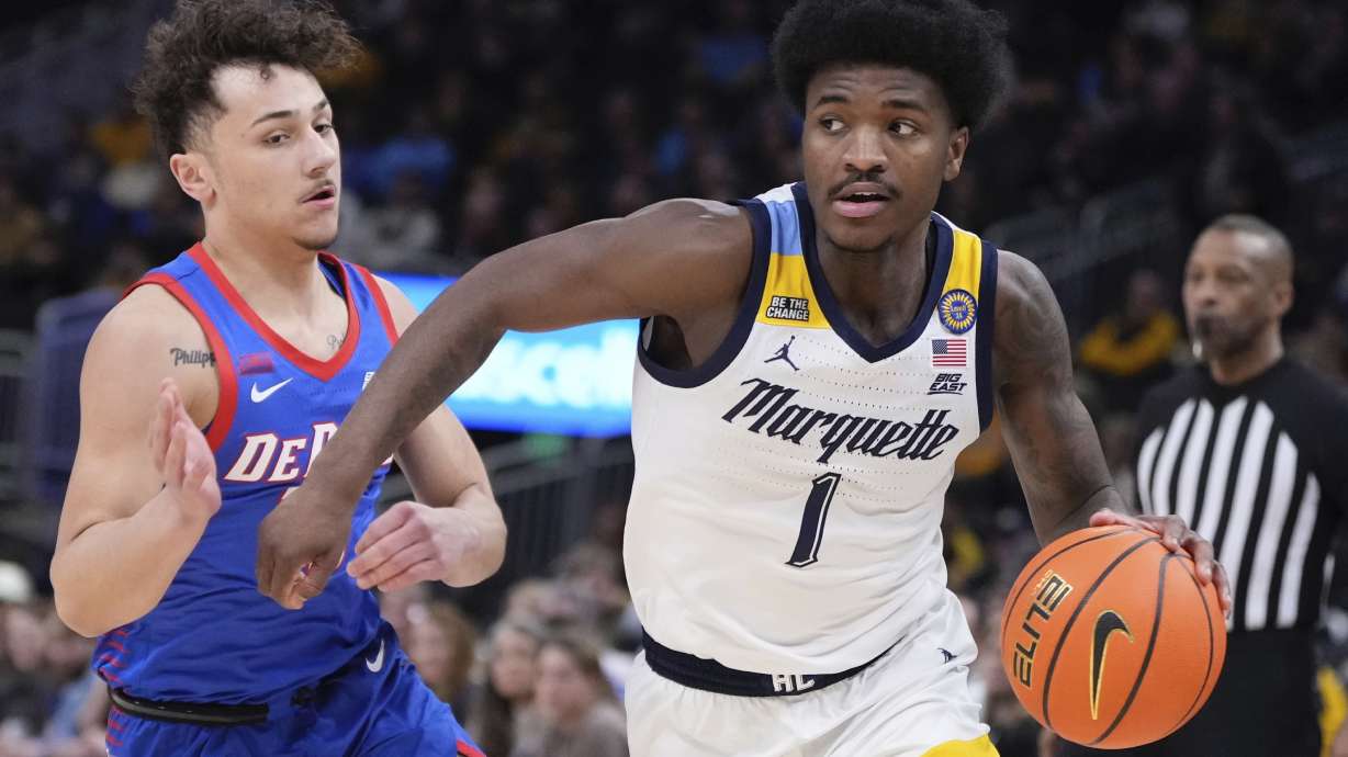 Marquette's Kam Jones drives past DePaul's Jacob Meyer during the first half of an NCAA college basketball game Tuesday, Feb. 11, 2025, in Milwaukee.