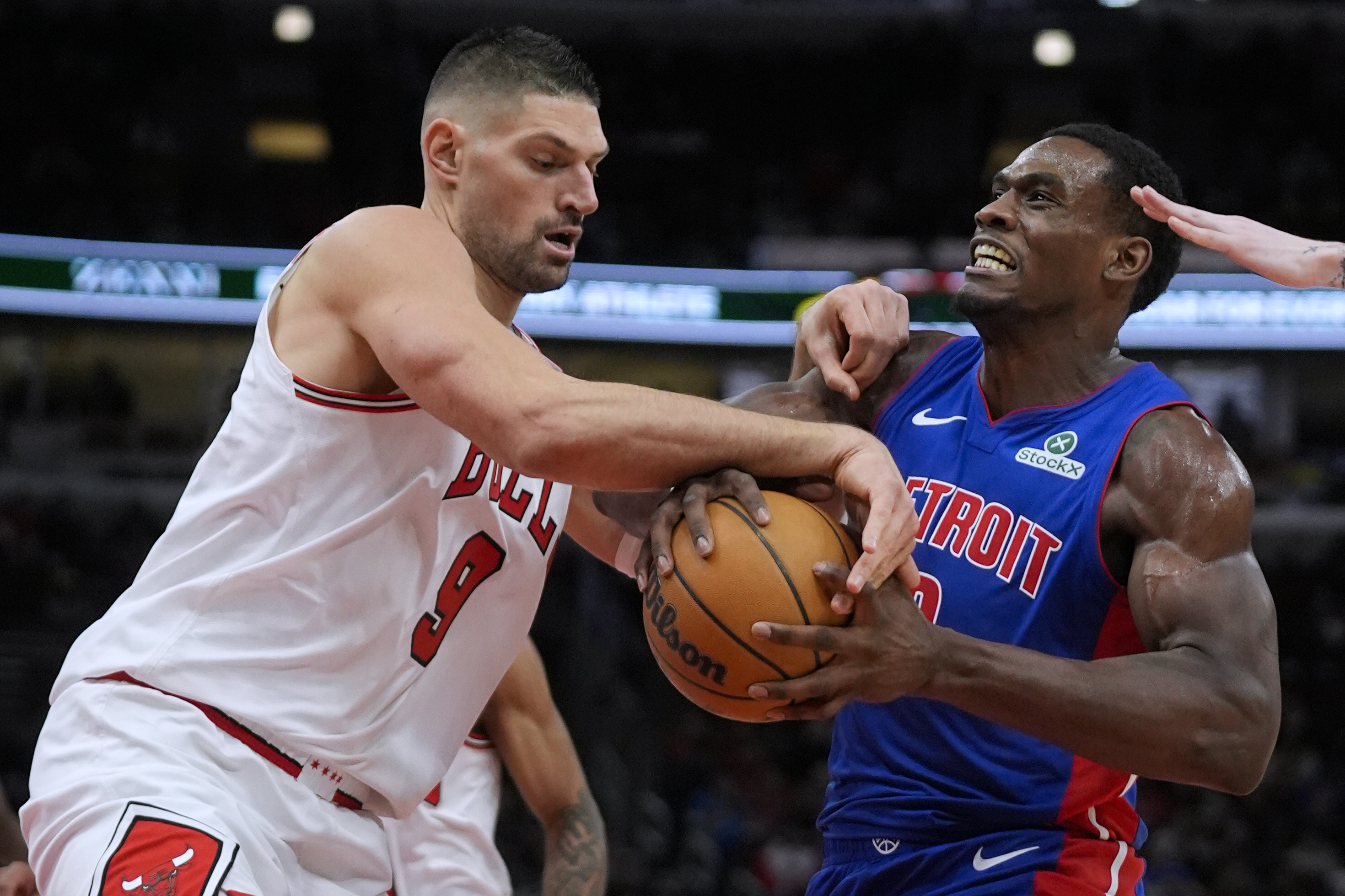 Chicago Bulls center Nikola Vucevic (9), left, tries to grab the ball from Detroit Pistons center Jalen Duren (0) during the first half of an NBA basketball game Tuesday, Feb. 11, 2025, in Chicago.