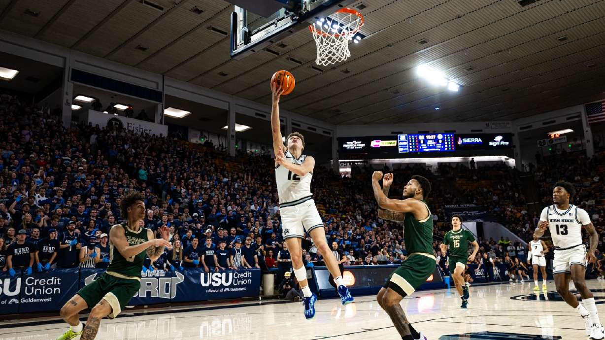 Utah State's Mason Falslev drives toward the basket in a game against Colorado State on Feb. 11, 2025 in Logan.