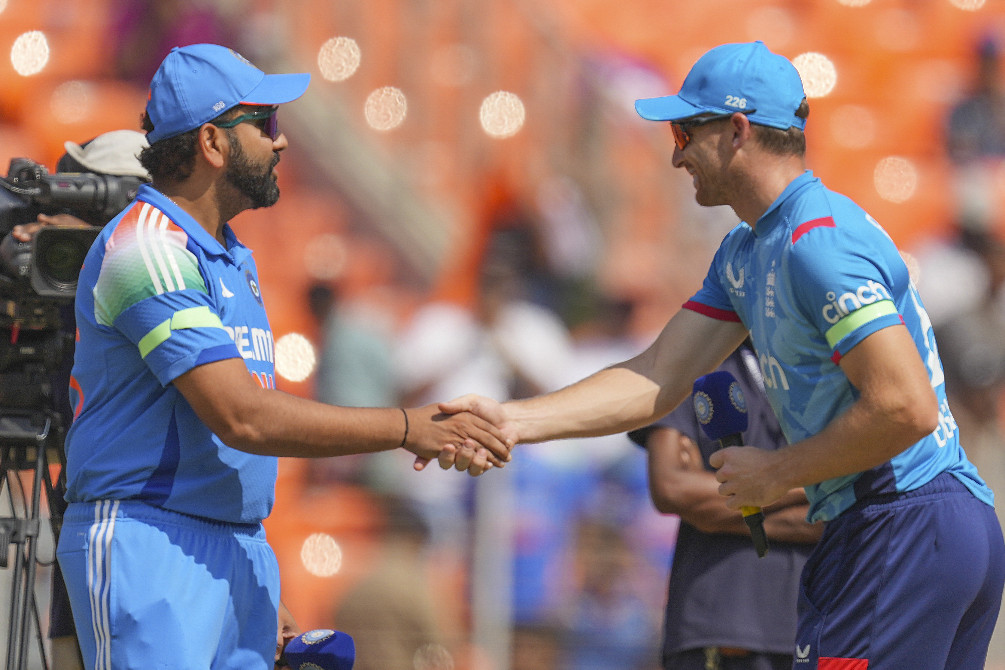 India's captain Rohit Sharma, left, shakes hand with his England counterpart Jos Buttler after the coin toss for the third one day international cricket match between India and England in Ahmedabad , India, Wednesday, Feb. 12, 2025.