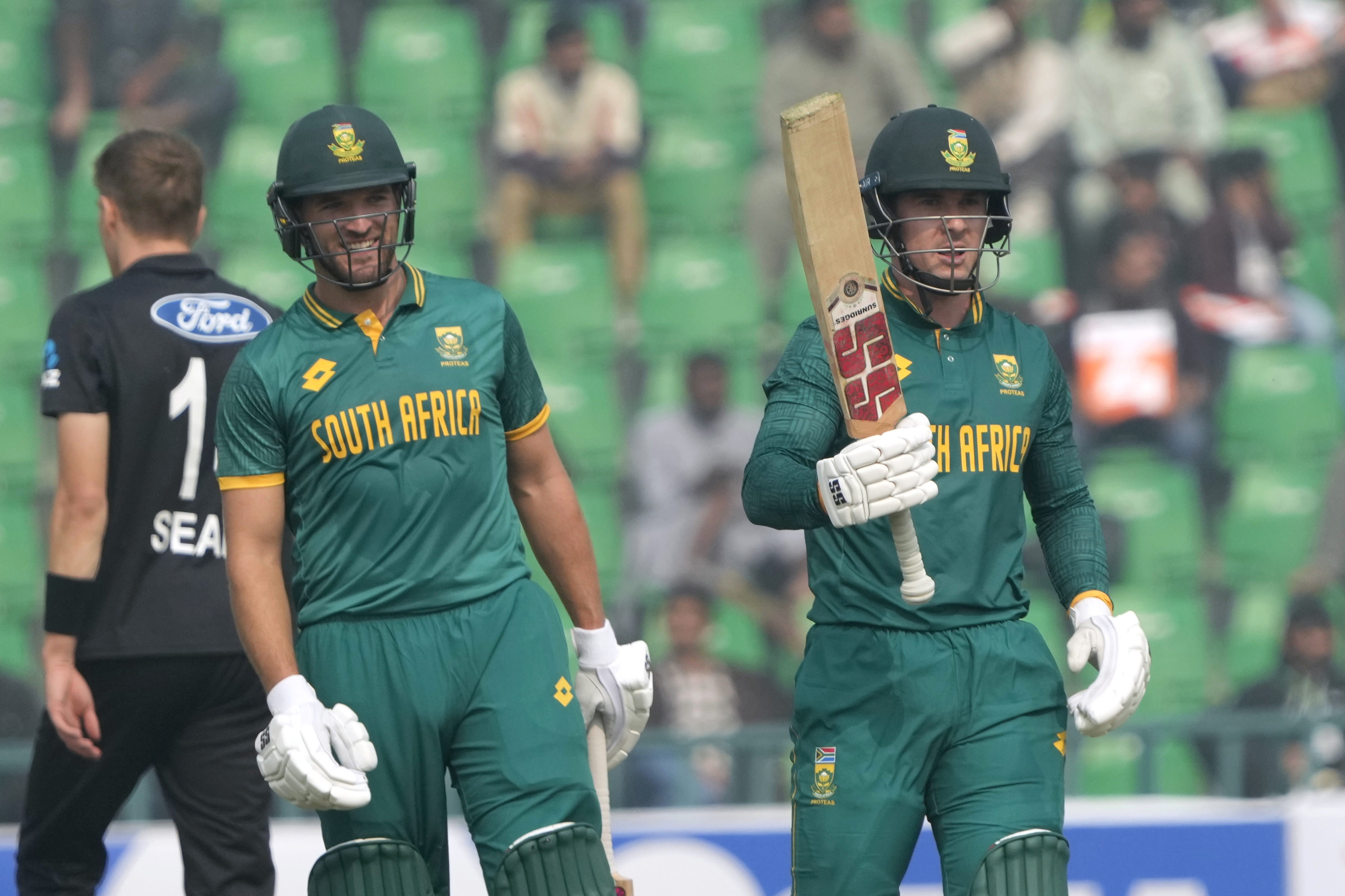 South Africa's Mathew Breetzke, right, celebrates after scoring 150 runs as teammate Wiaan Mulderafter smiles during the tri-series ODI cricket match between New Zealand and South Africa, in Lahore, Pakistan, Monday, Feb. 10, 2025.