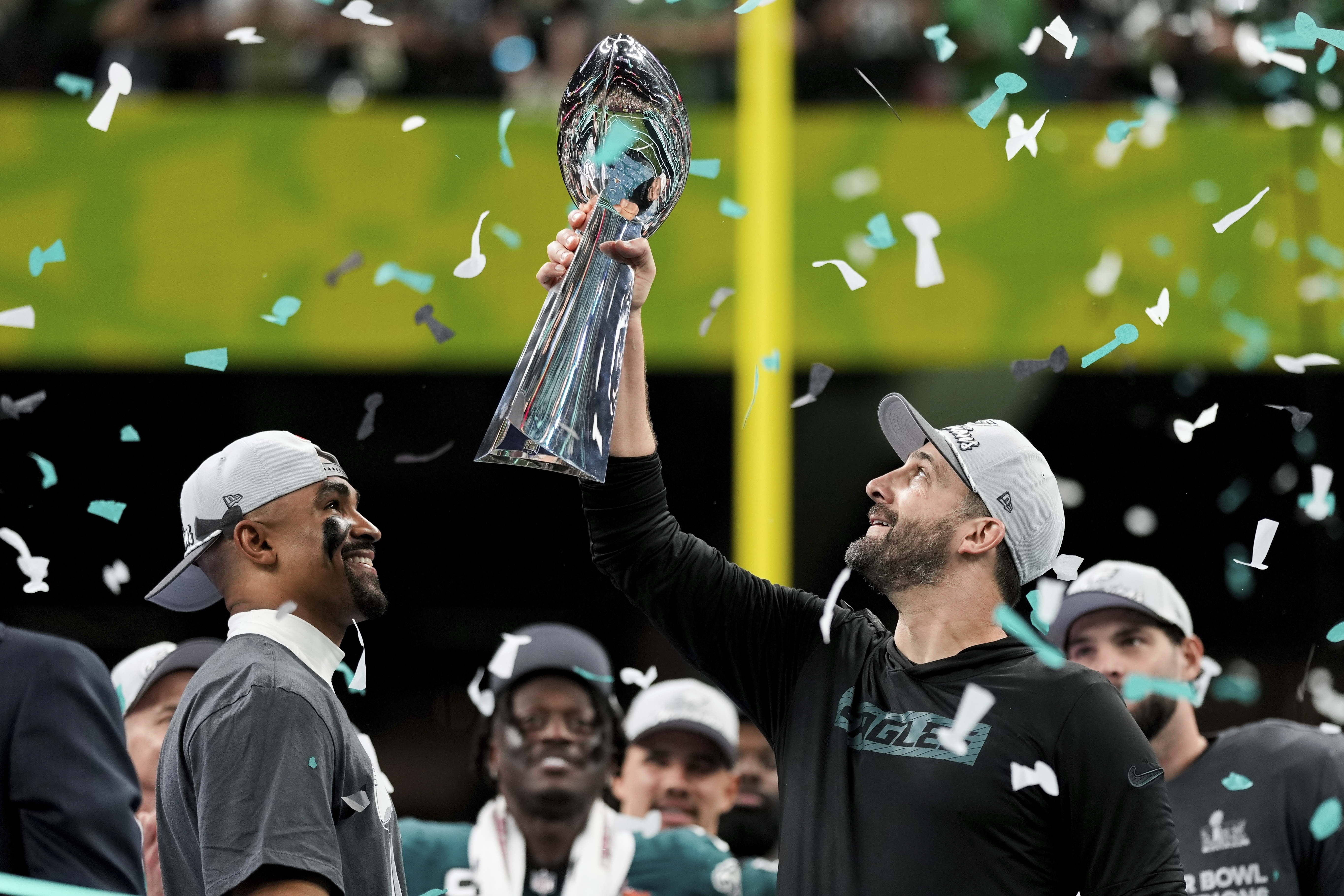 Philadelphia Eagles head coach Nick Sirianni, right, lifts the Vince Lombardi Trophy next to quarterback Jalen Hurts after defeating the Kansas City Chiefs in the NFL Super Bowl 59 football game, Sunday, Feb. 9, 2025, in New Orleans.
